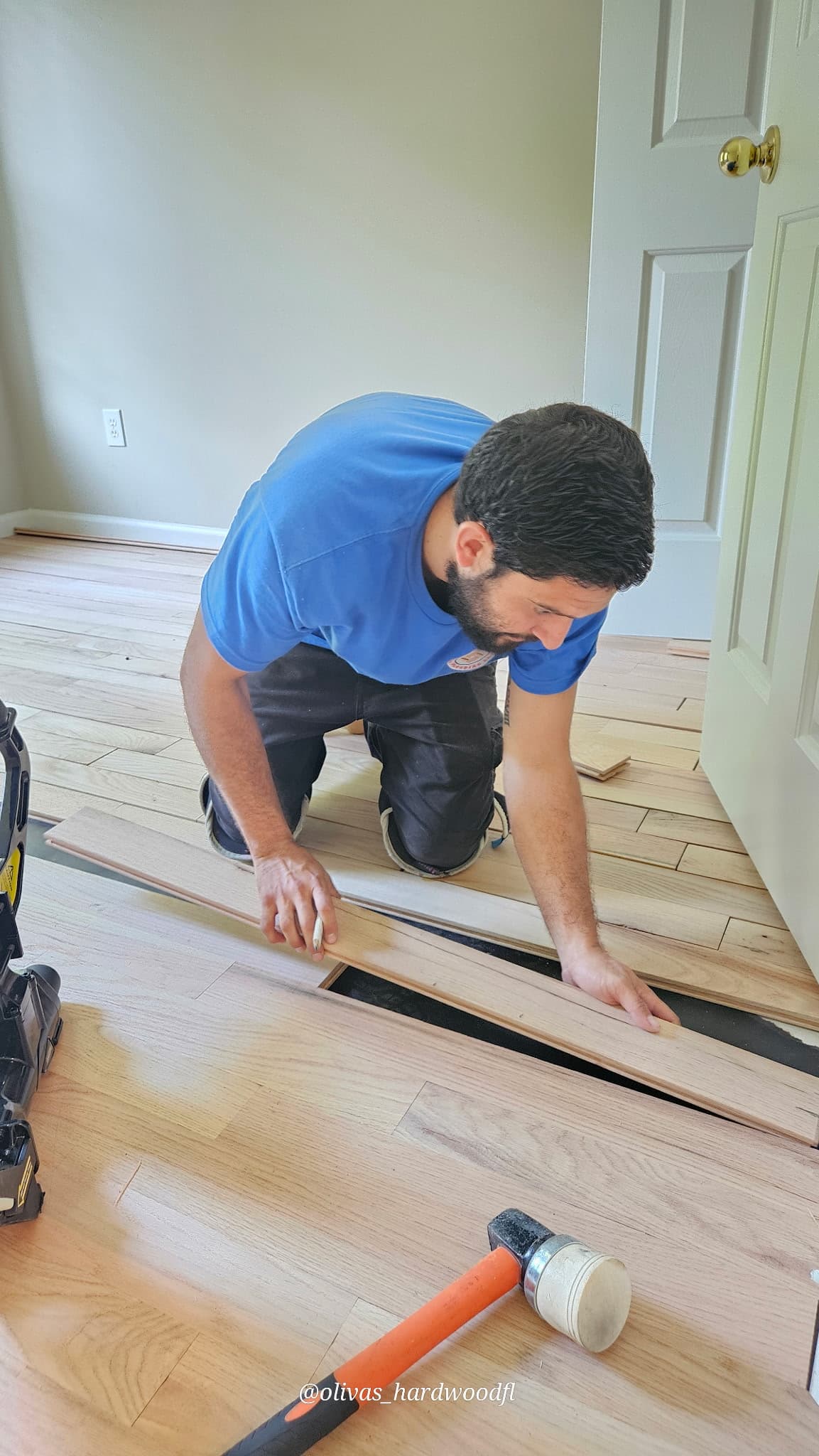 Hardwood flooring being installed with professional tools and precision