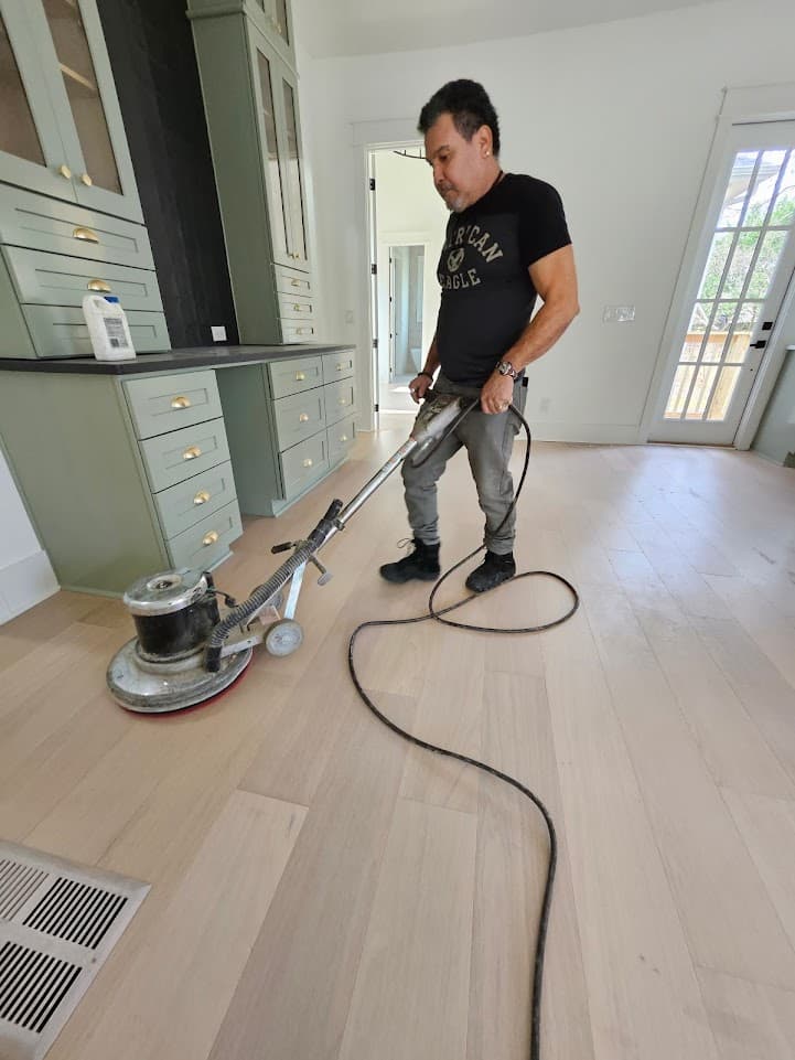 Crew buffing natural oak floor in a kitchen in Atlanta, GA