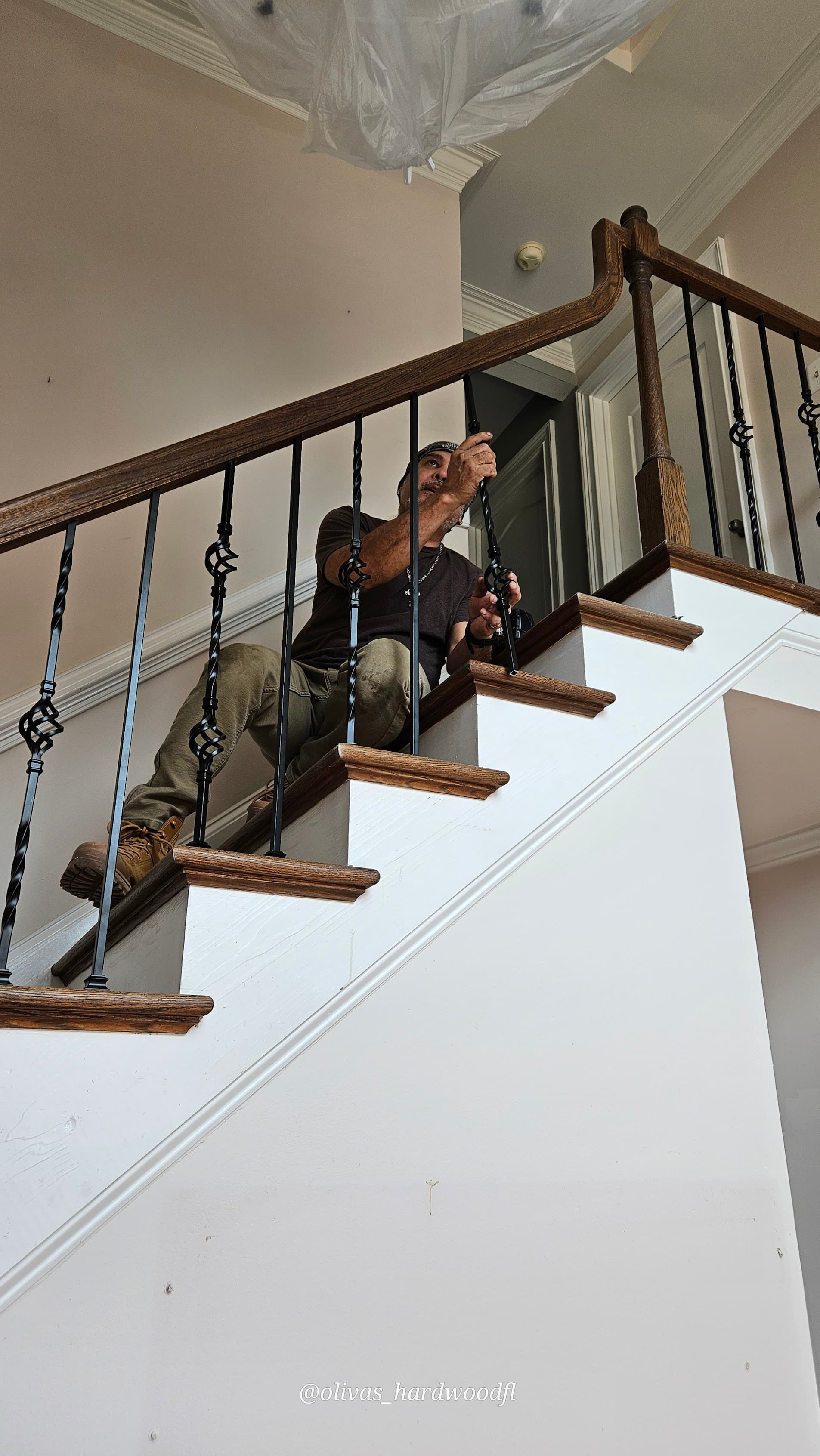 Crew installing iron balusters on a staircase in Lawrenceville, GA