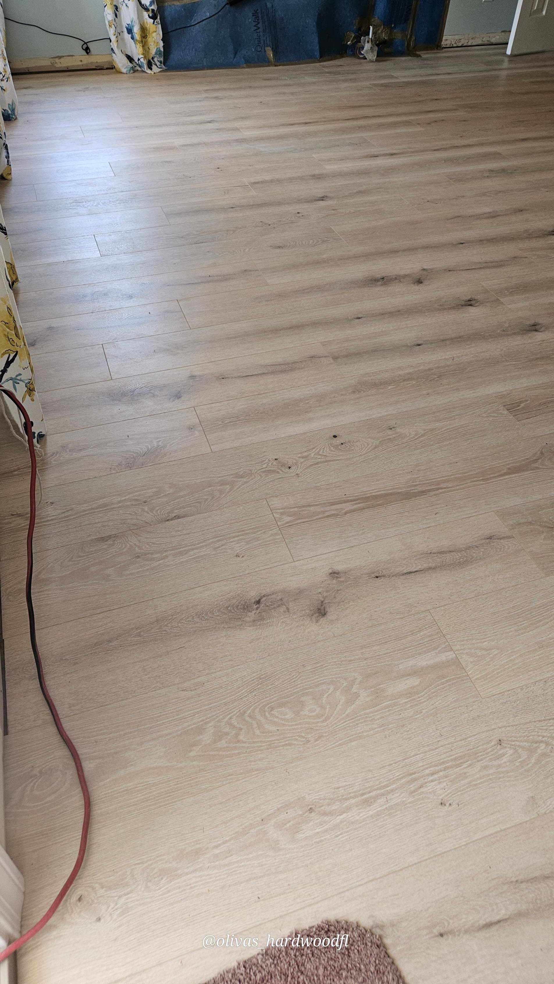 Engineered hardwood floor installation in Lawrenceville GA — wide plank natural oak glue-down method with pneumatic tools
