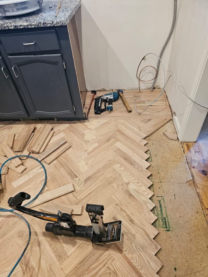 Herringbone hardwood floor installation in Alpharetta GA — flooring nailer used for red oak parquet installation