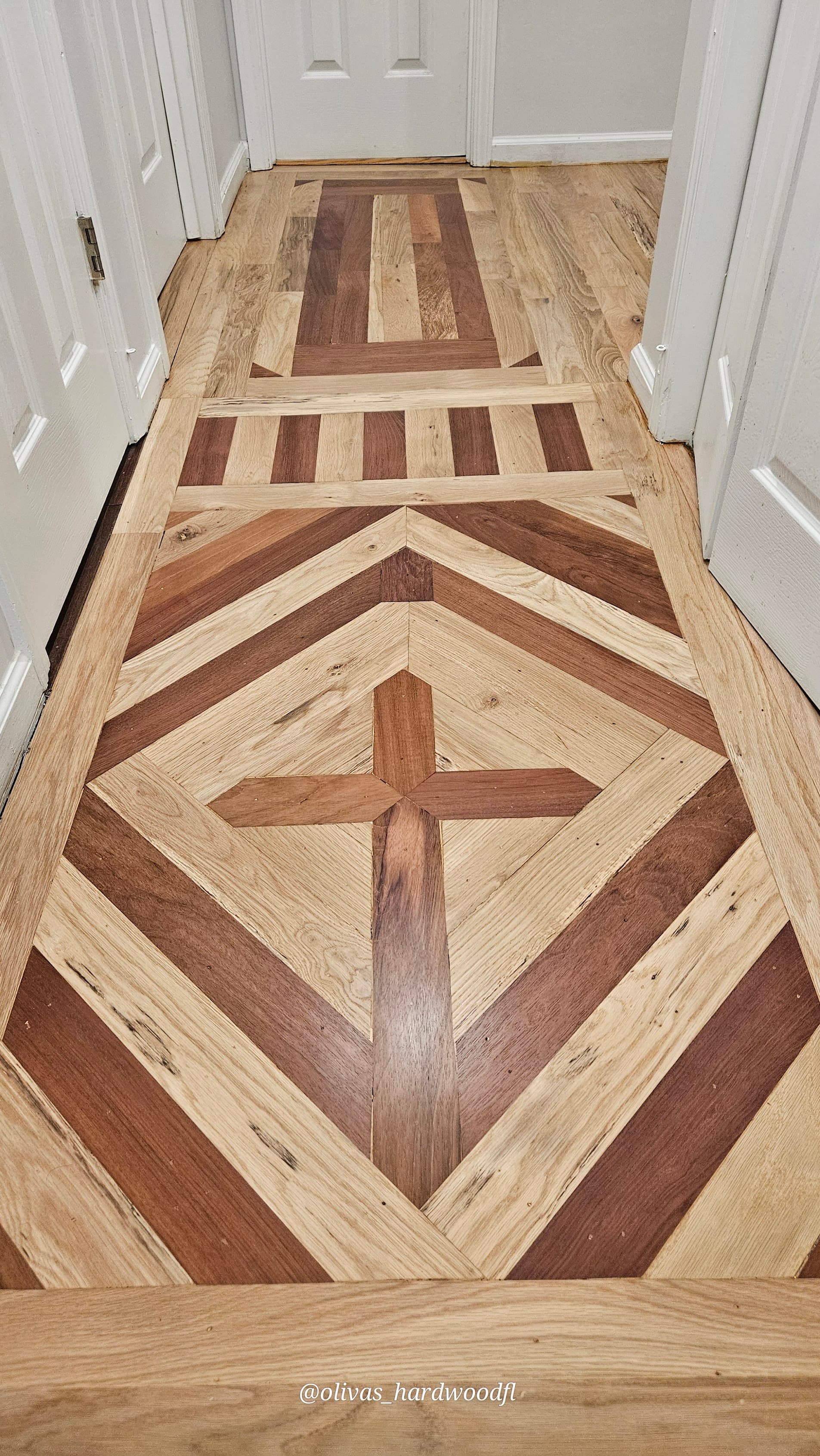 Custom parquet medallion hardwood floor installation in Marietta GA — hand-laid diamond pattern with mixed wood species