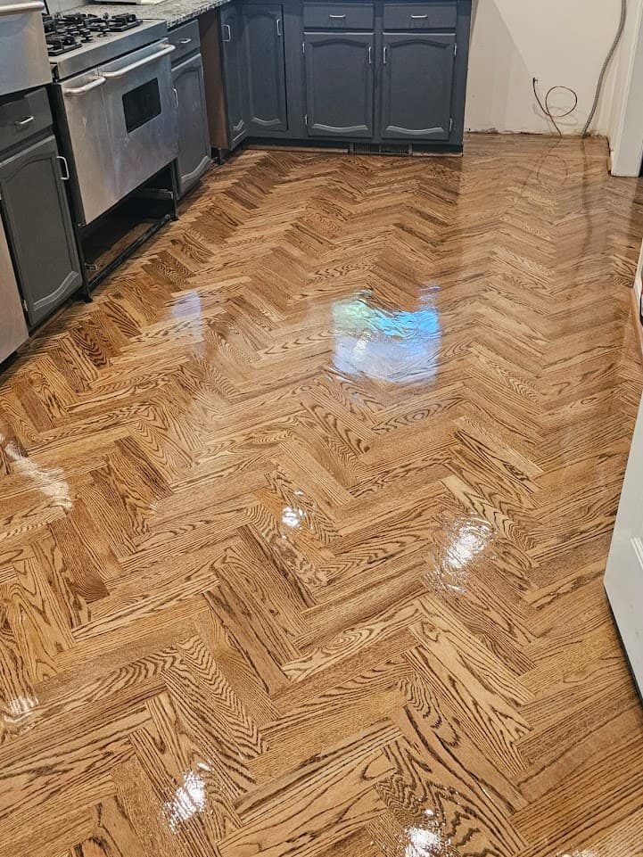 Herringbone hardwood floor refinishing in Atlanta GA — medium stain red oak kitchen with fresh gloss finish