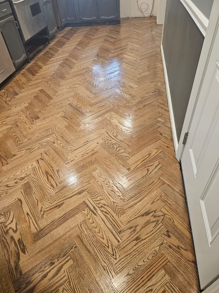 Herringbone hardwood floor refinishing in Duluth GA — medium stain red oak kitchen and hallway finished