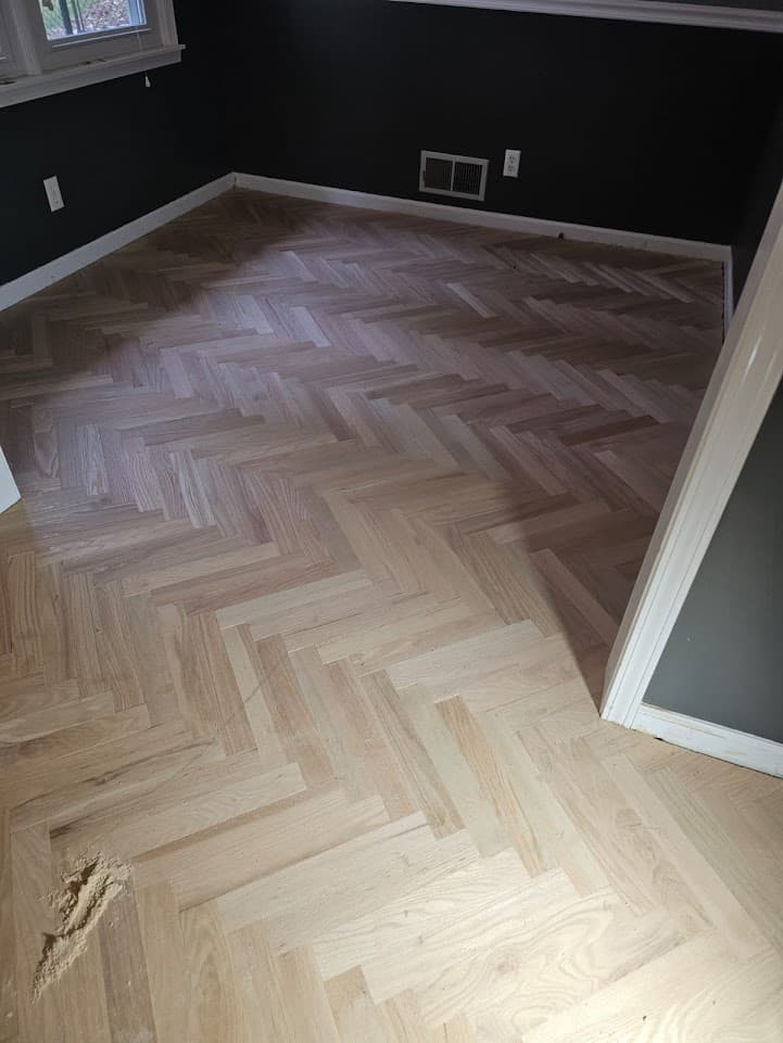 Herringbone hardwood floor dark stain application in Atlanta GA — red oak parquet bedroom