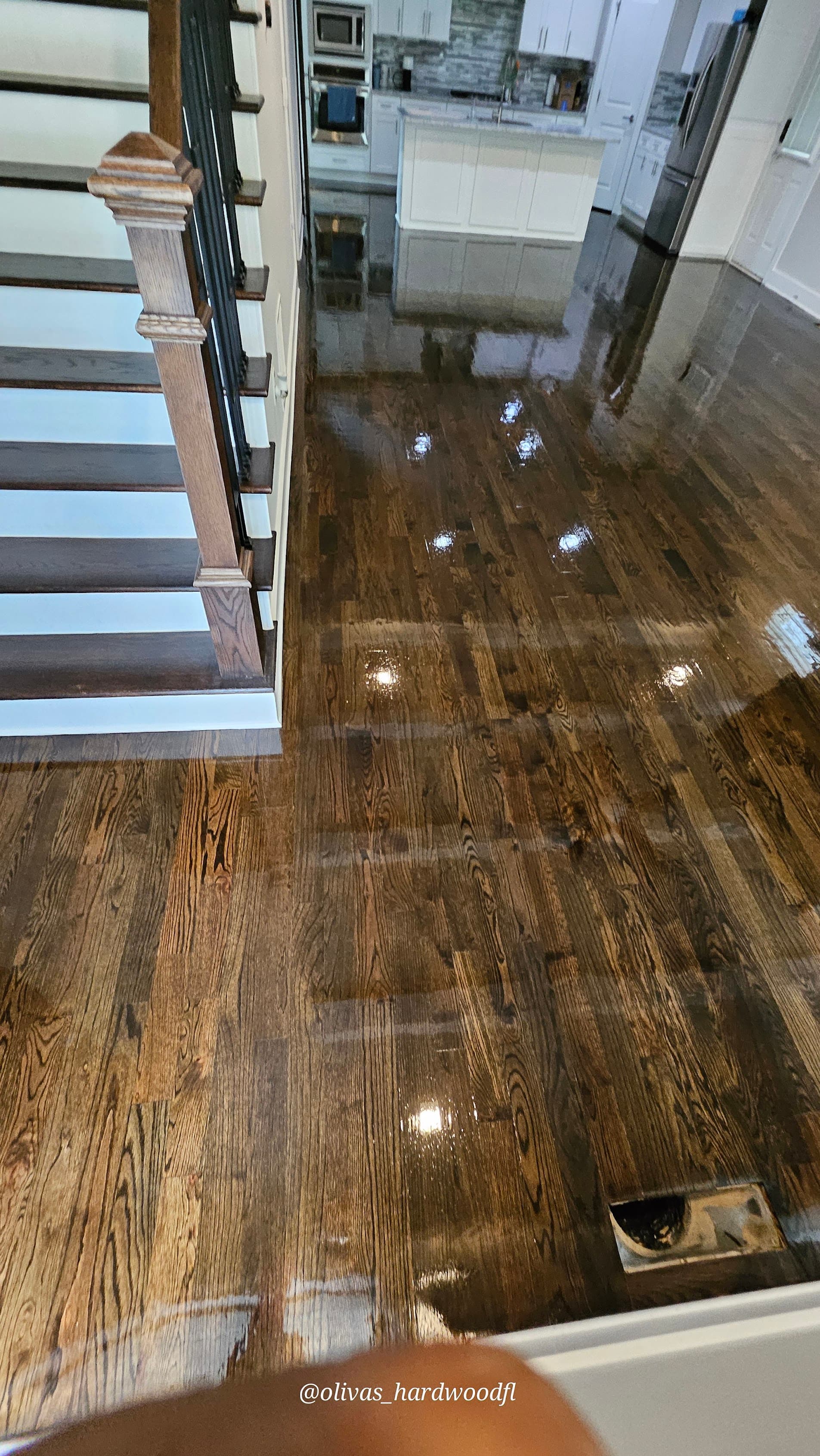 Hardwood floor refinishing in Lawrenceville GA — dark espresso stain oak foyer with fresh wet polyurethane finish