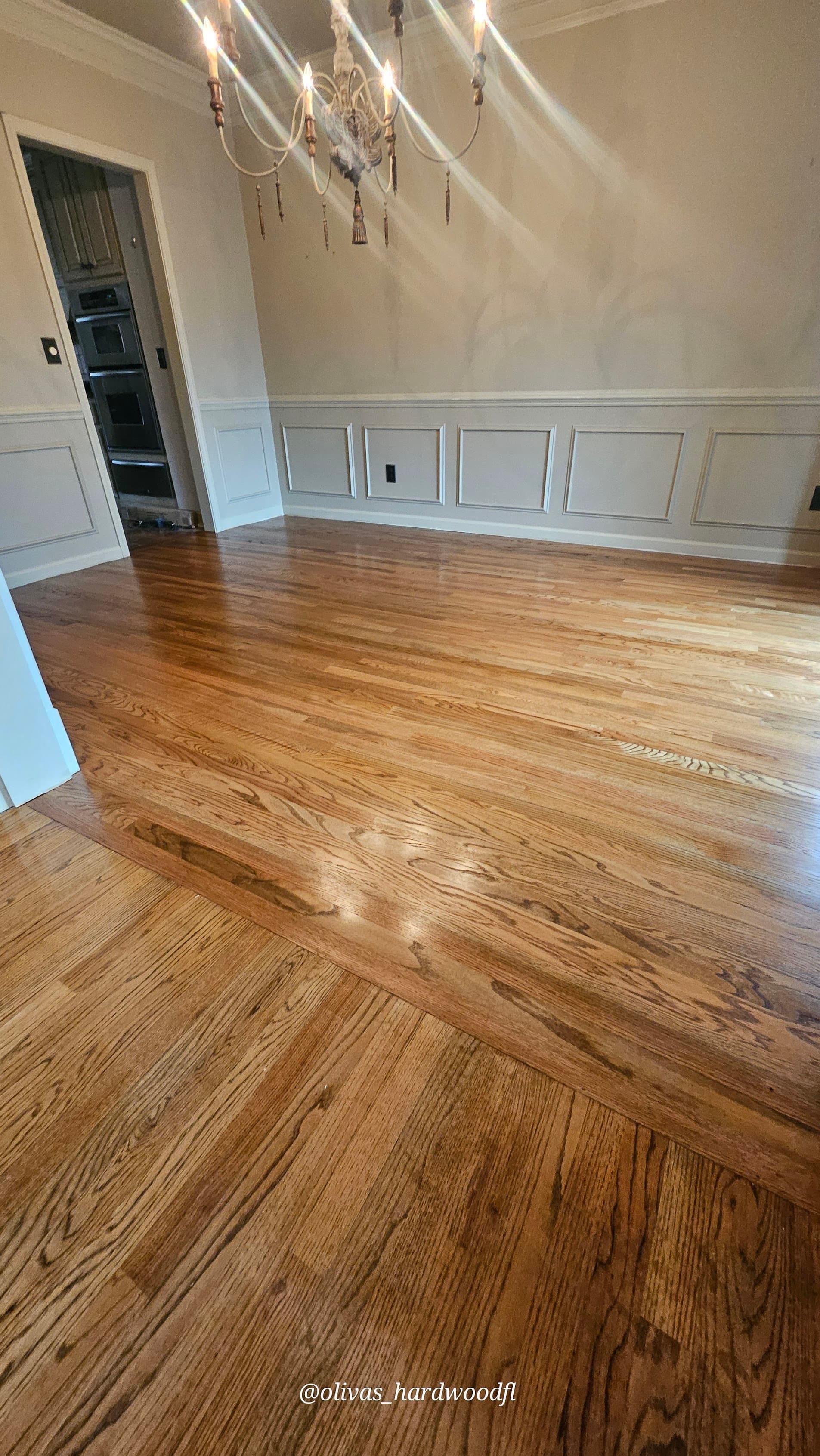 Hardwood floor refinishing in Alpharetta GA — gunstock stain red oak formal dining room with chandelier