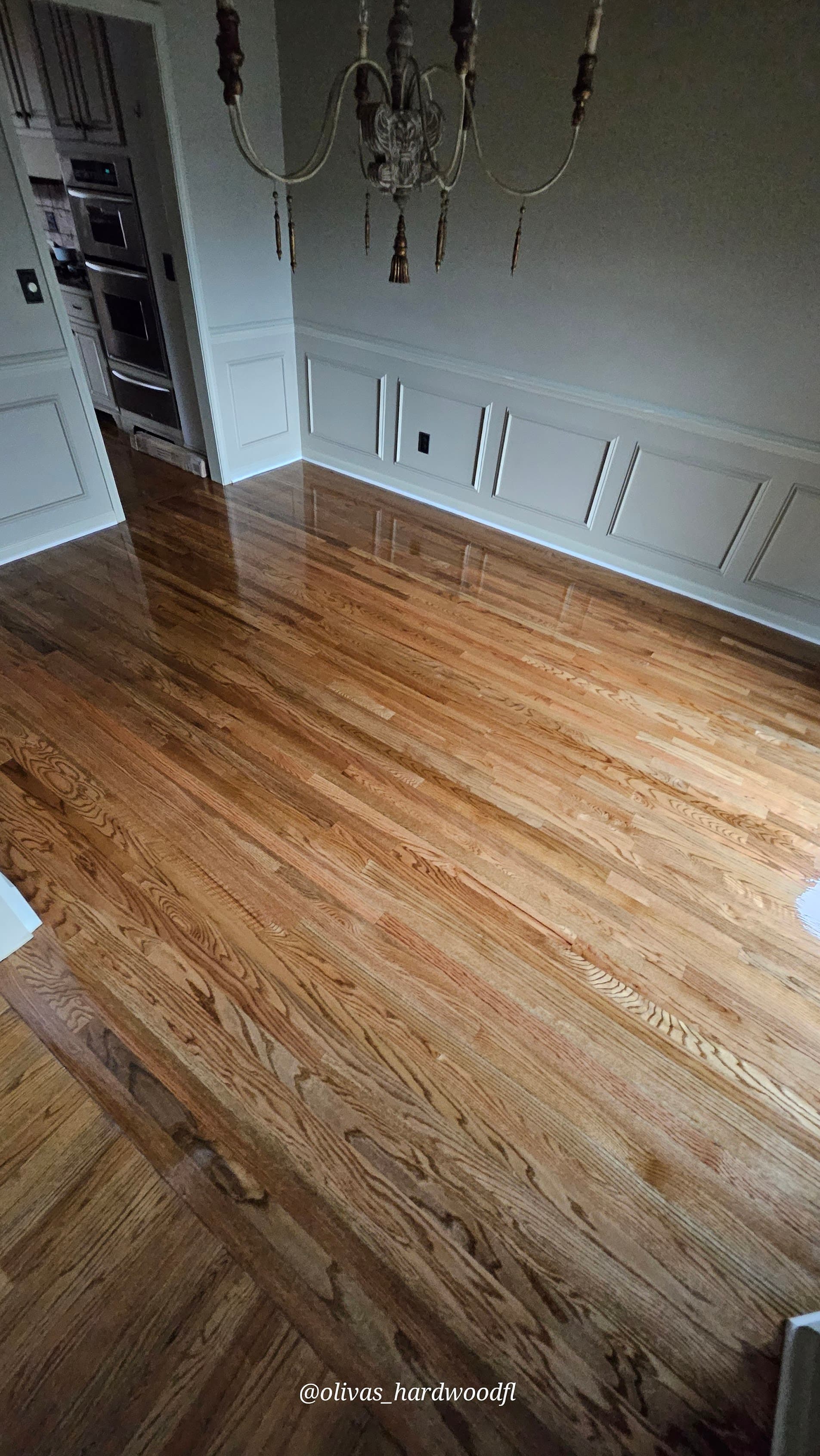 Hardwood floor refinishing in Sandy Springs GA — gunstock stain red oak open dining room into kitchen