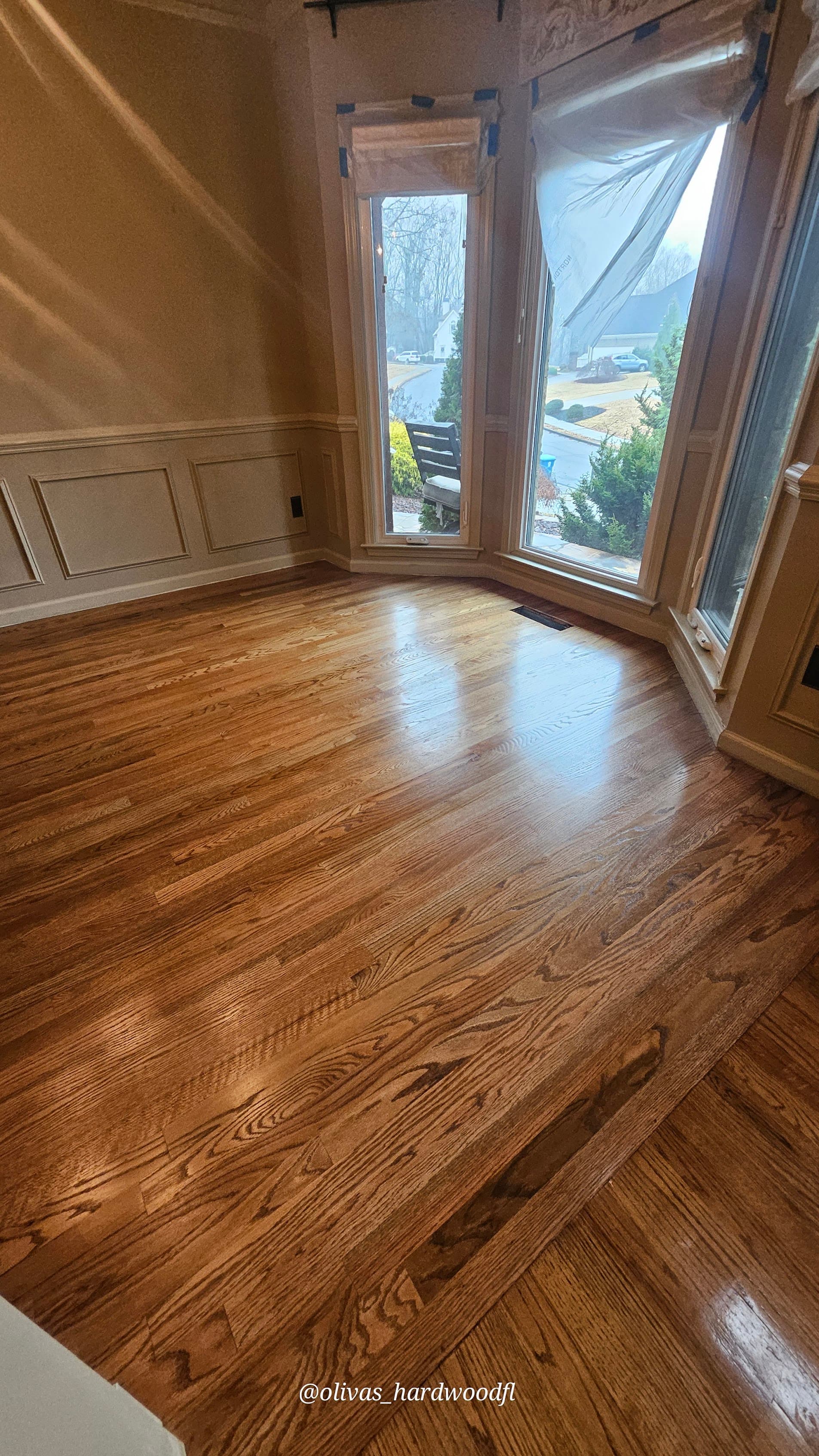 Hardwood floor refinishing in Marietta GA — gunstock stain red oak breakfast nook with bay window