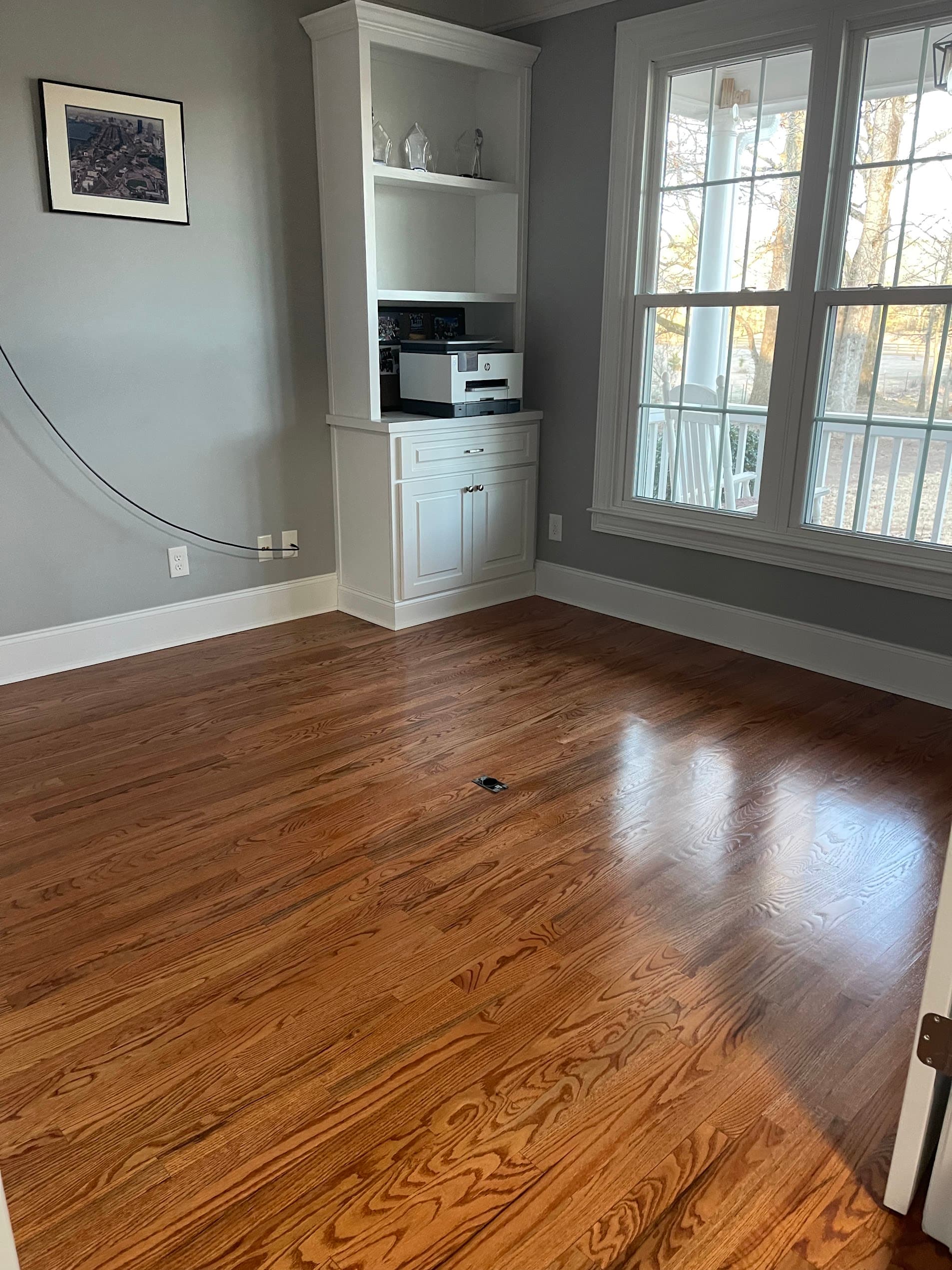 Hardwood floor refinishing in Marietta GA — gunstock stain red oak home office with white built-in shelving