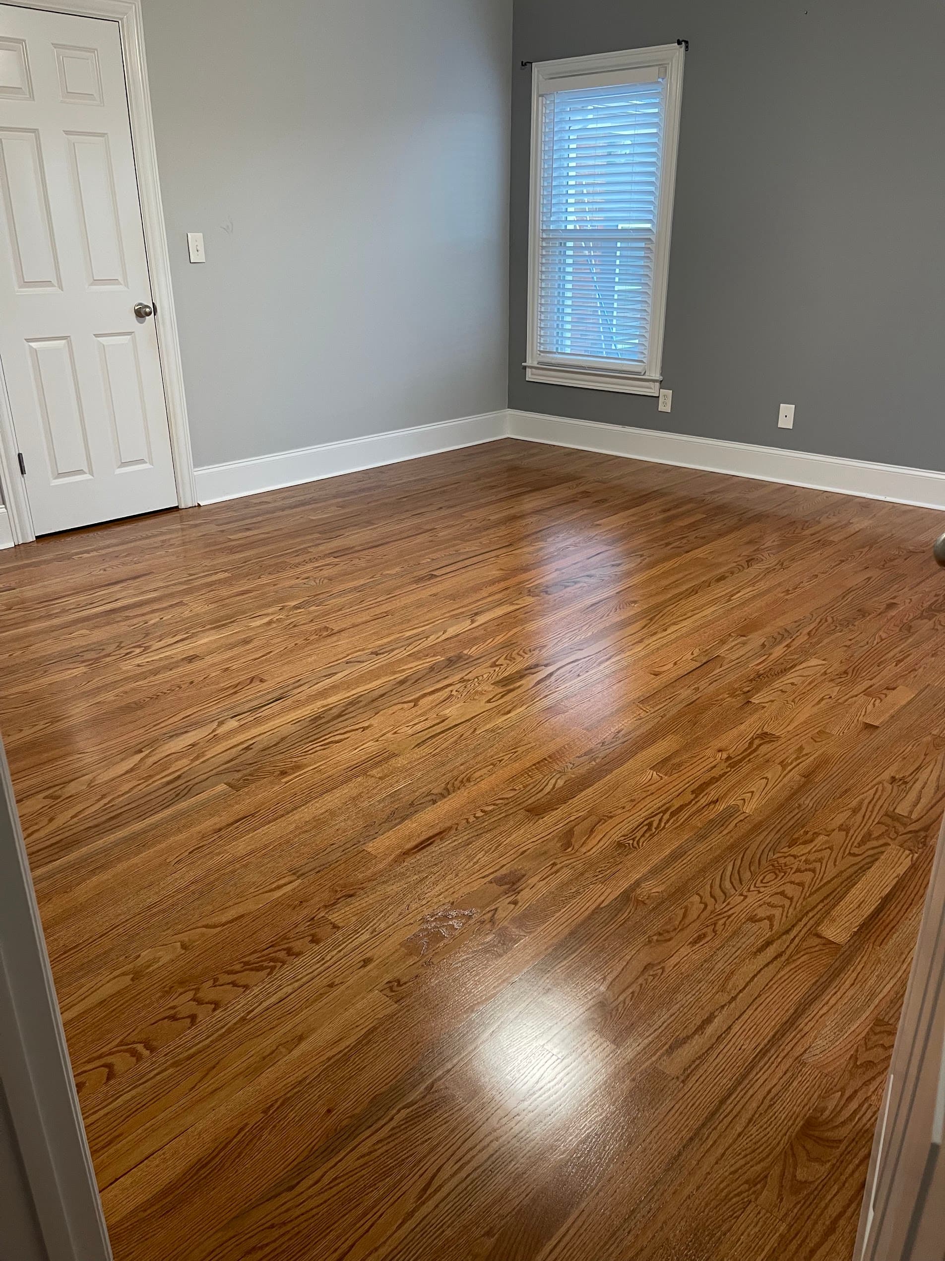 Hardwood floor refinishing in Duluth GA — gunstock stain red oak bedroom refinished to a satin sheen