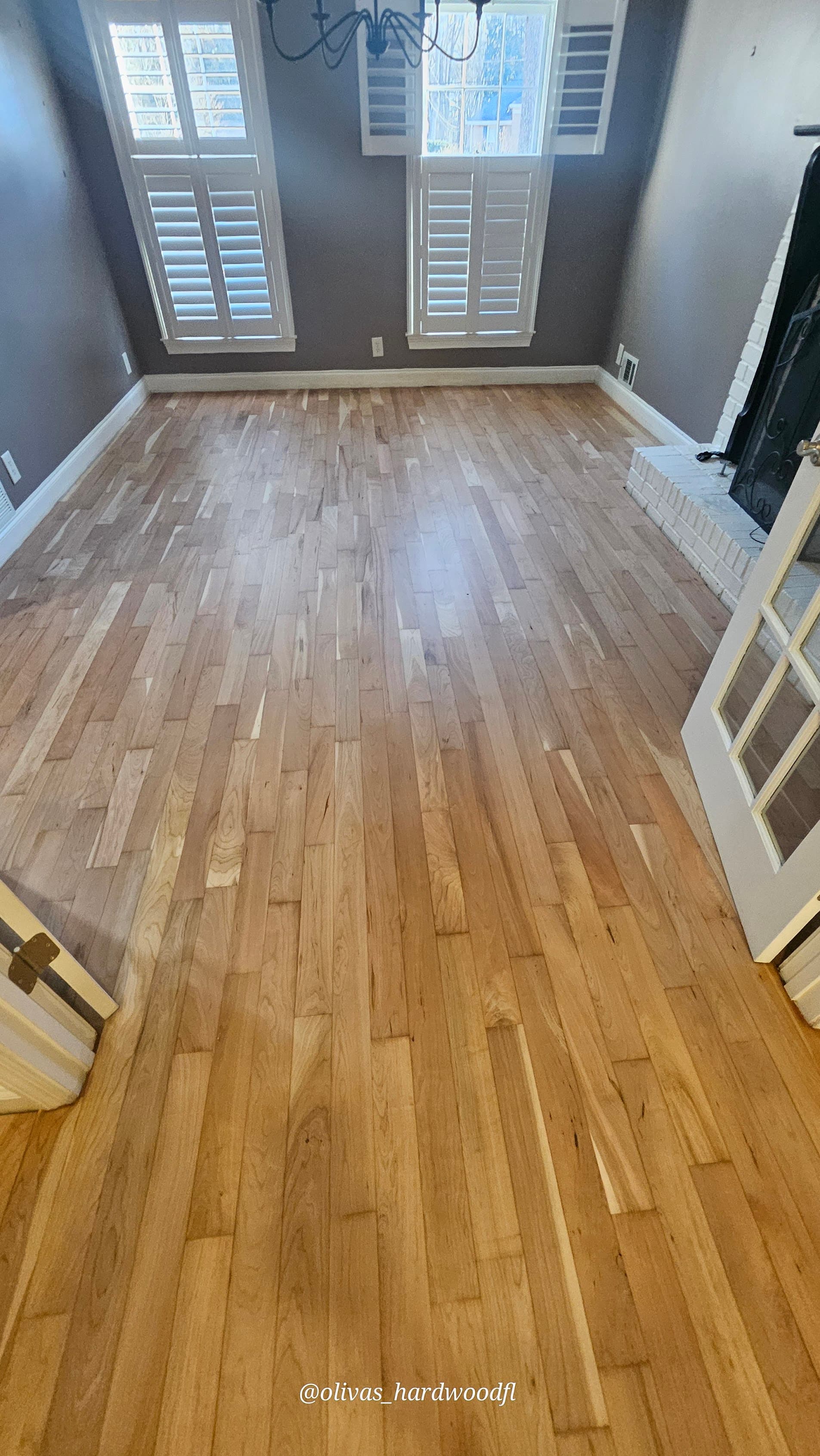 Hardwood floor refinishing in Atlanta GA — natural honey oak dining room with plantation shutters