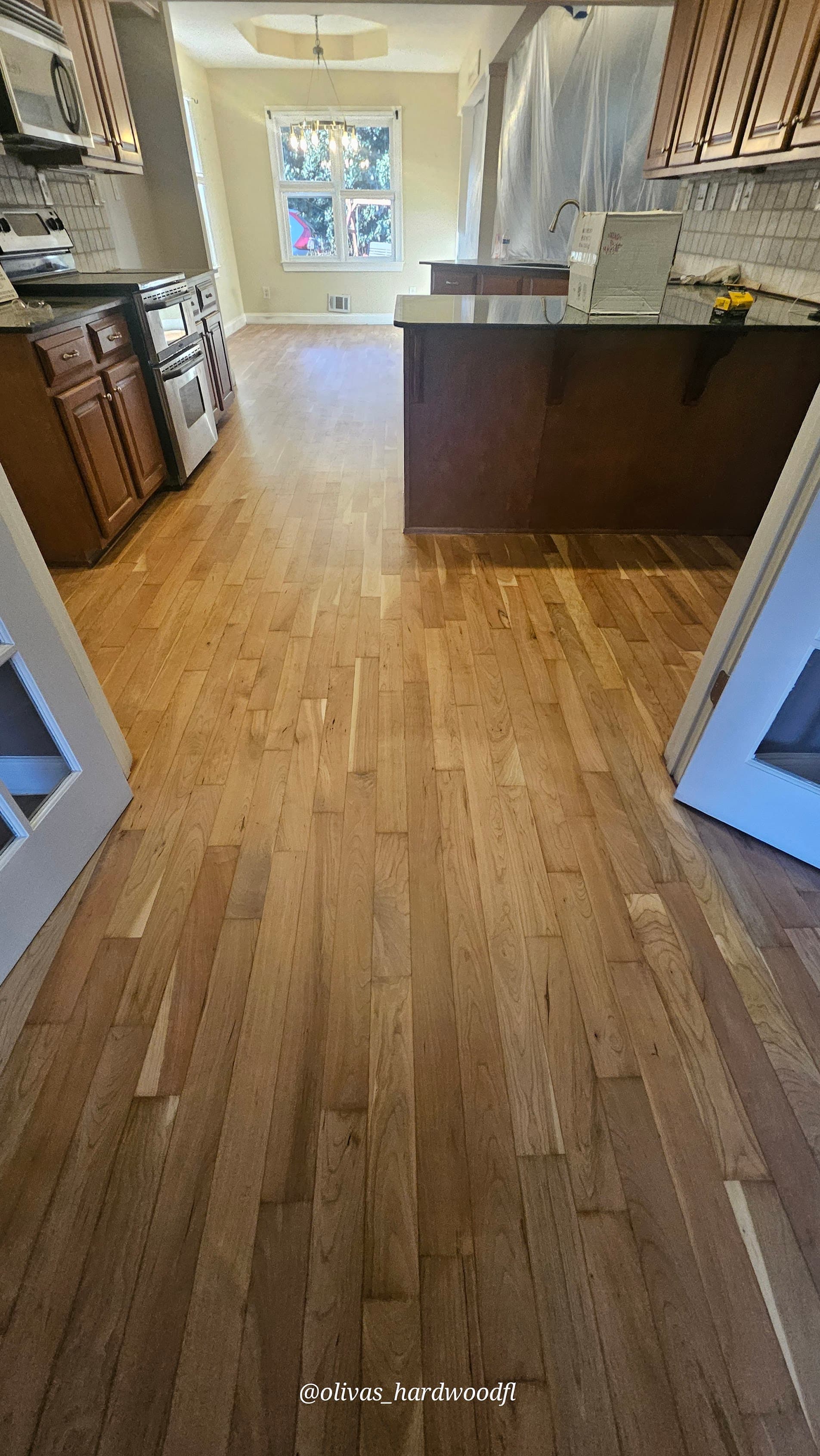 Hardwood floor refinishing in Duluth GA — natural honey oak open plan kitchen and living area