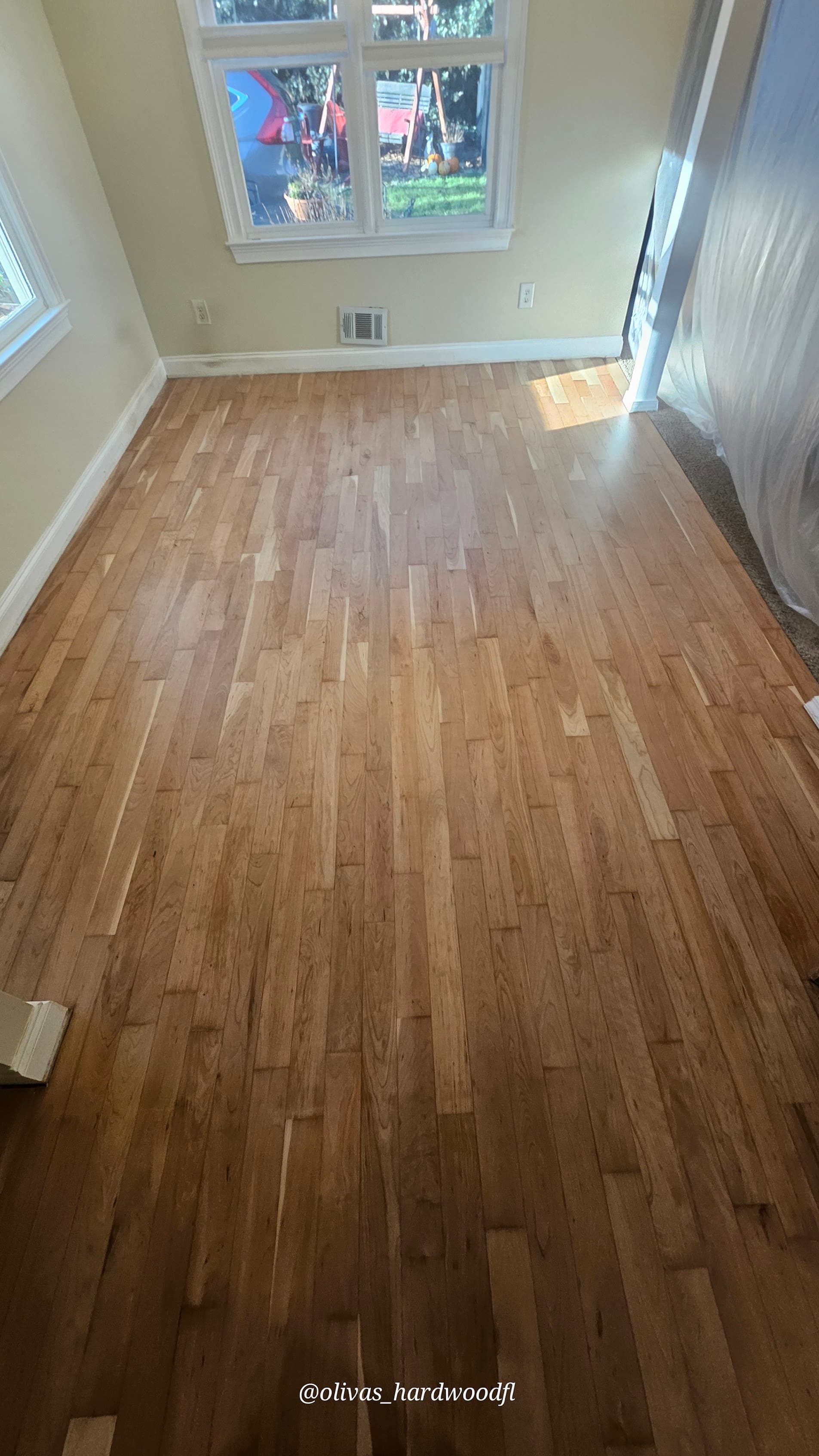 Hardwood floor refinishing in Lawrenceville GA — natural honey oak bedroom with satin polyurethane finish