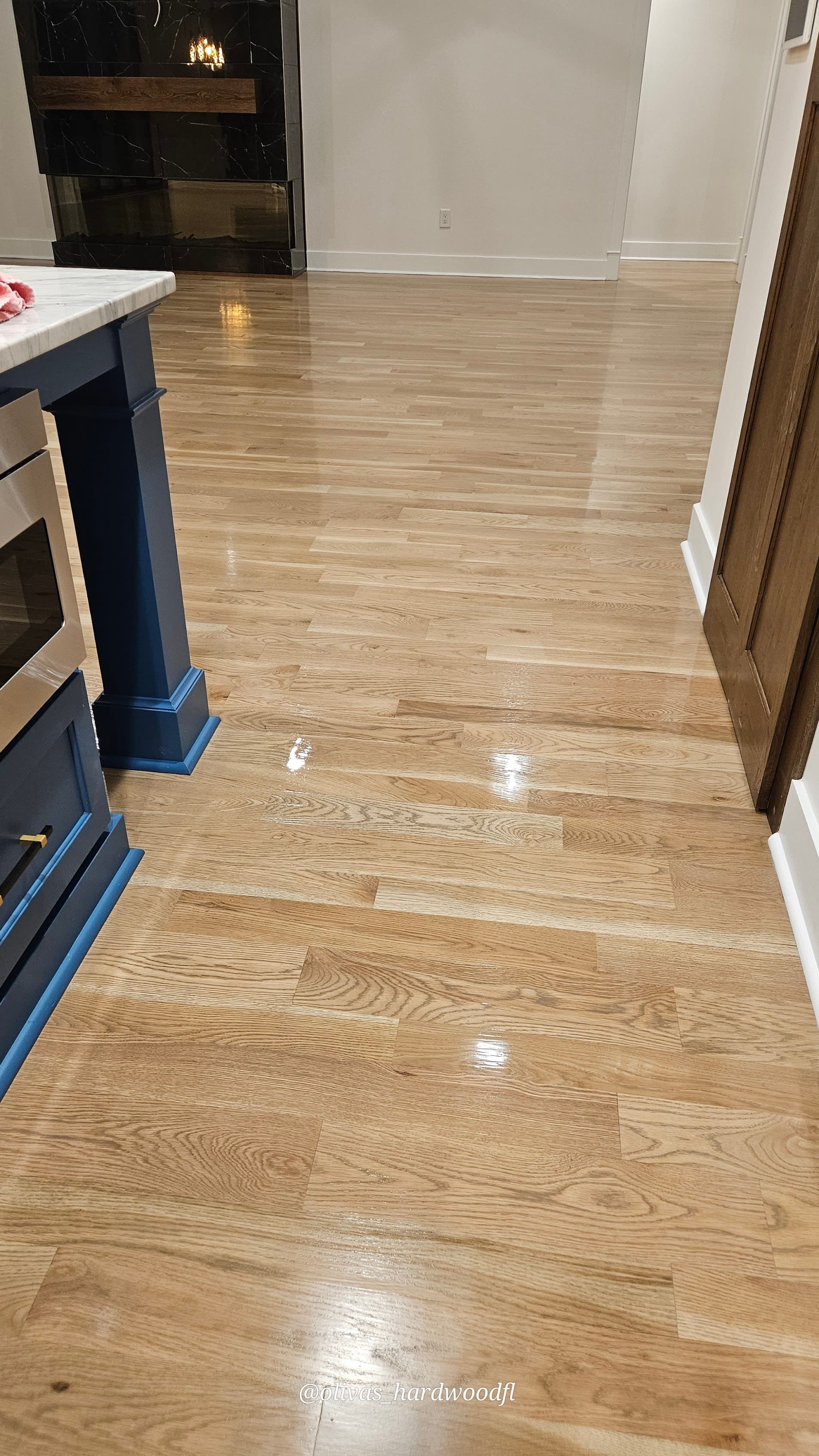 Hardwood floor refinishing in Marietta GA — natural white oak high-gloss kitchen with stone fireplace
