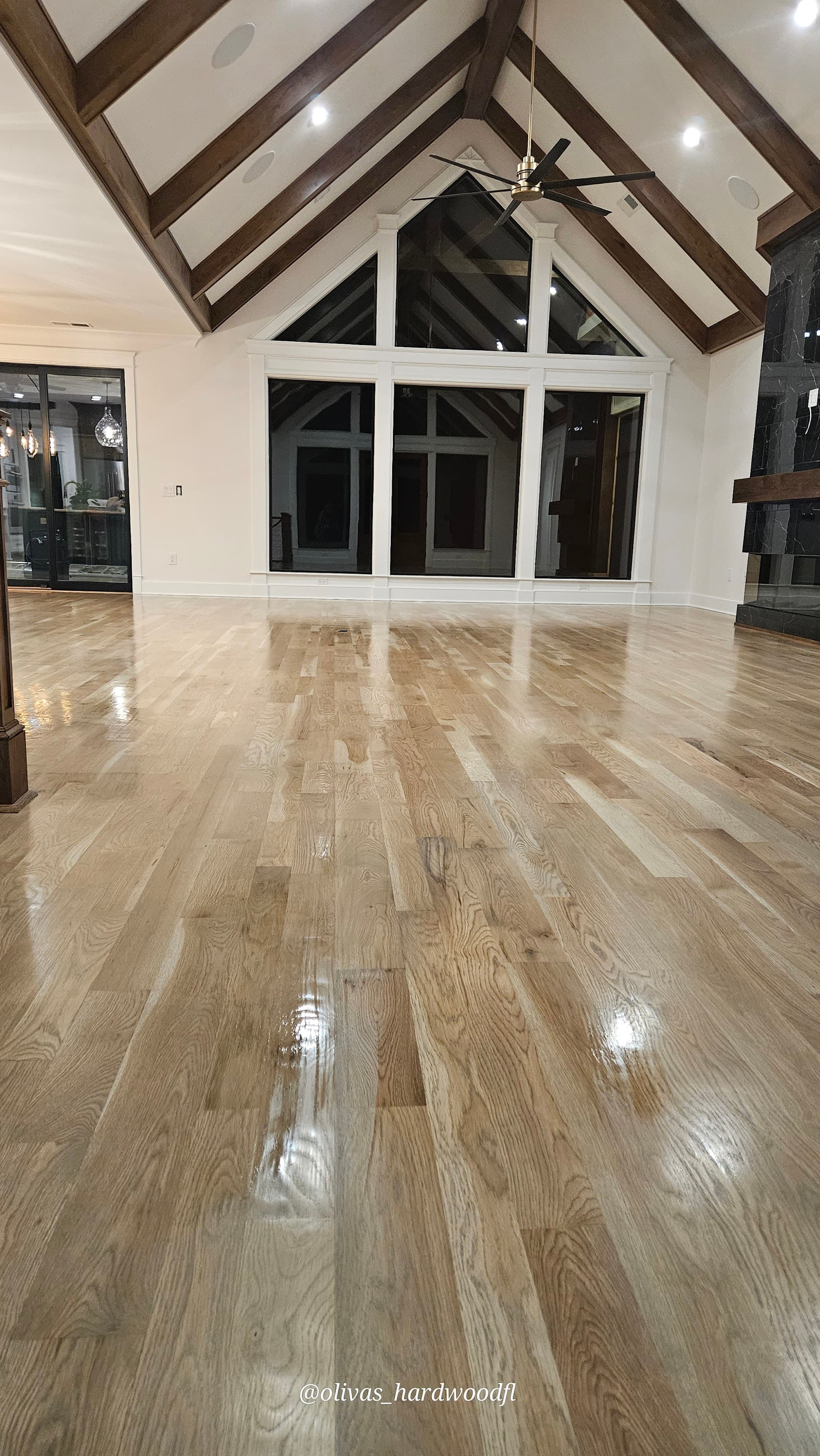 Hardwood floor refinishing in Gwinnett County GA — natural white oak great room with vaulted ceiling and exposed beams