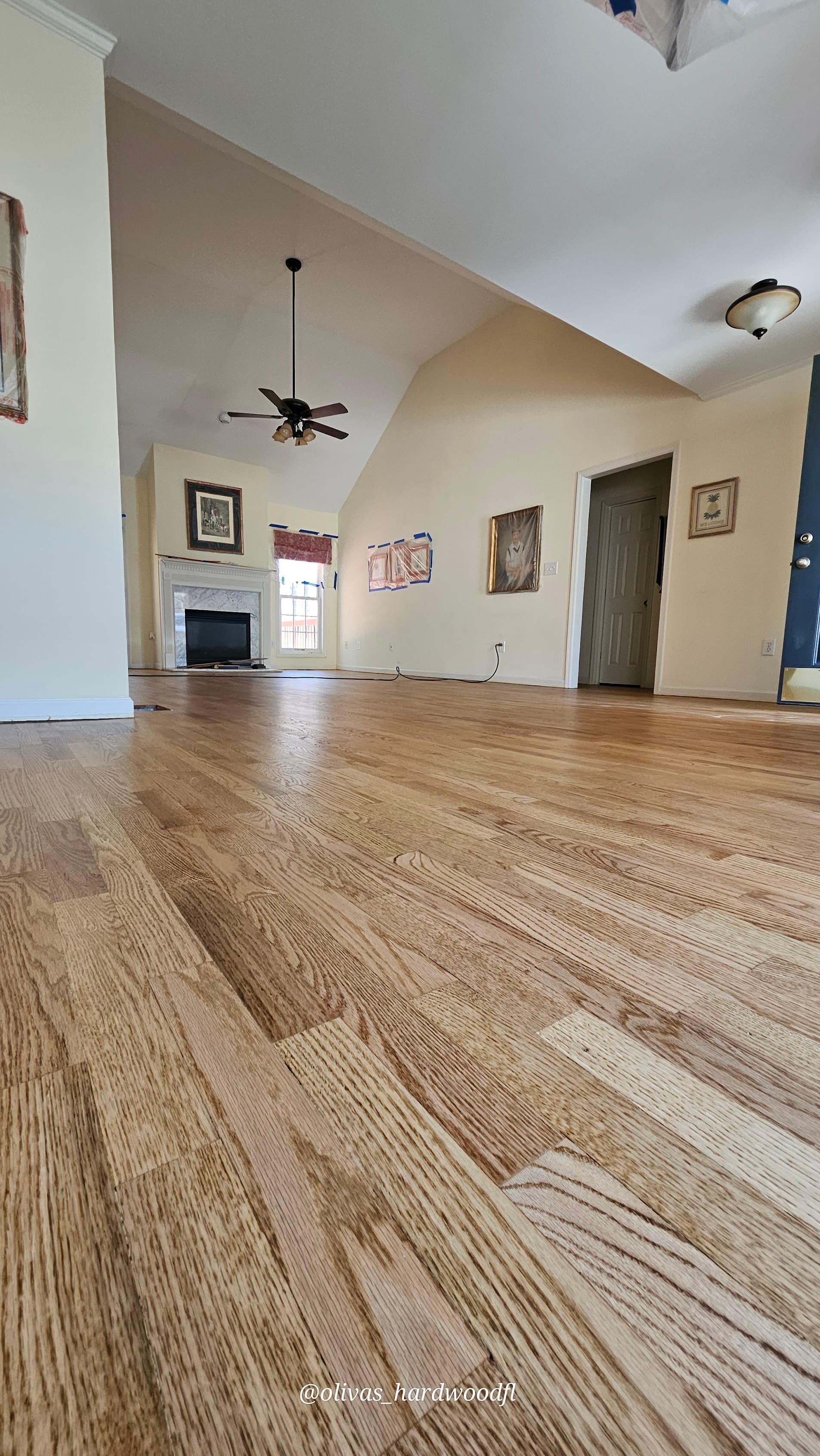 Hardwood floor sanding and refinishing in Sandy Springs GA — natural oak living room with vaulted ceiling