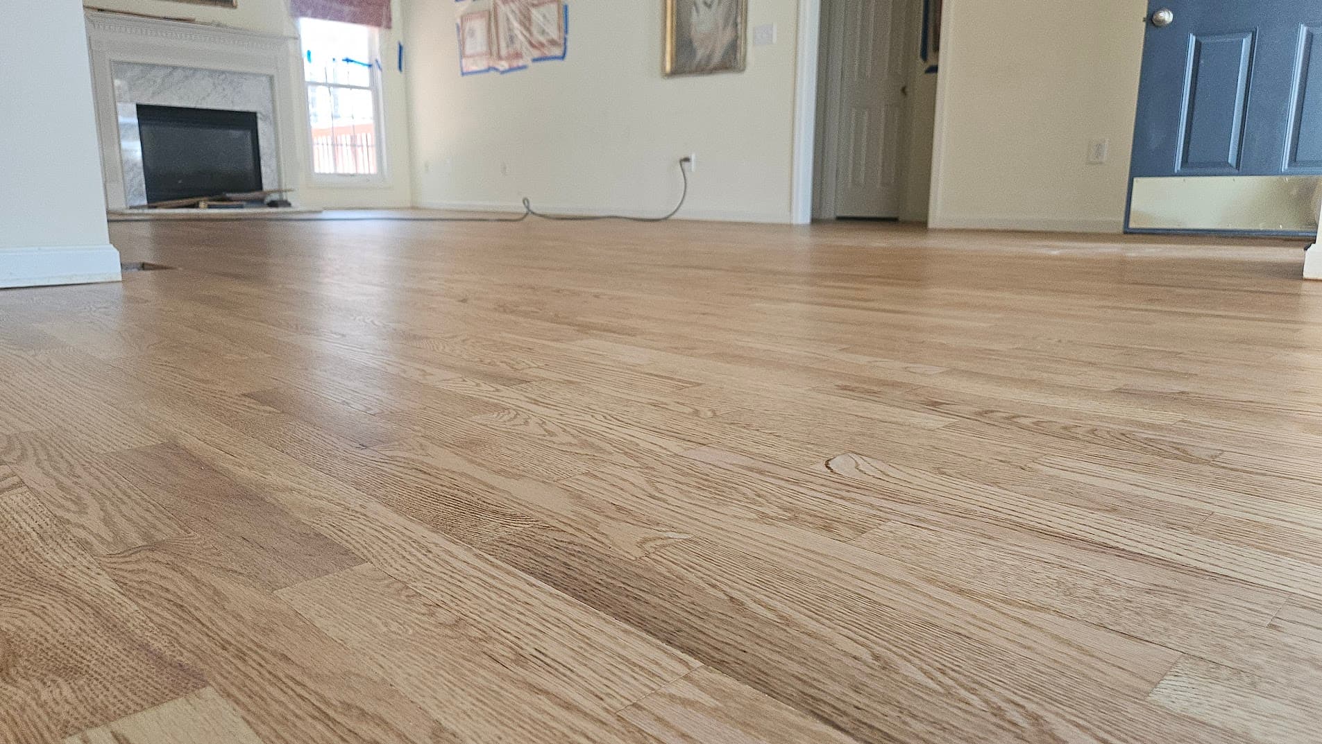 Hardwood floor sanding in Johns Creek GA — natural oak floor close-up showing smooth surface before finishing