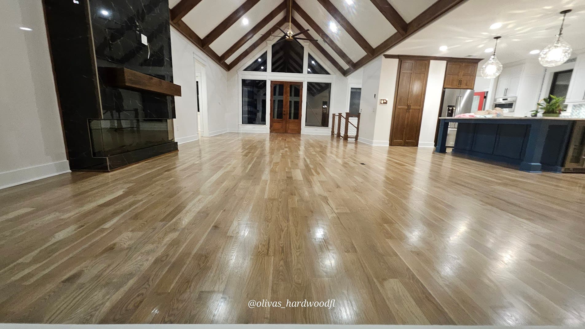 Hardwood floor refinishing in Decatur GA — natural white oak great room high-gloss finish with blue kitchen island