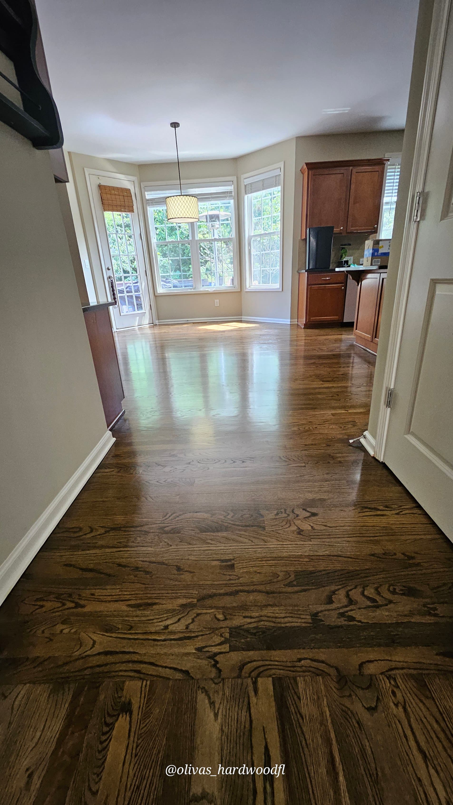 Hardwood floor refinishing in Duluth GA — dark espresso stain oak dining room with bay window
