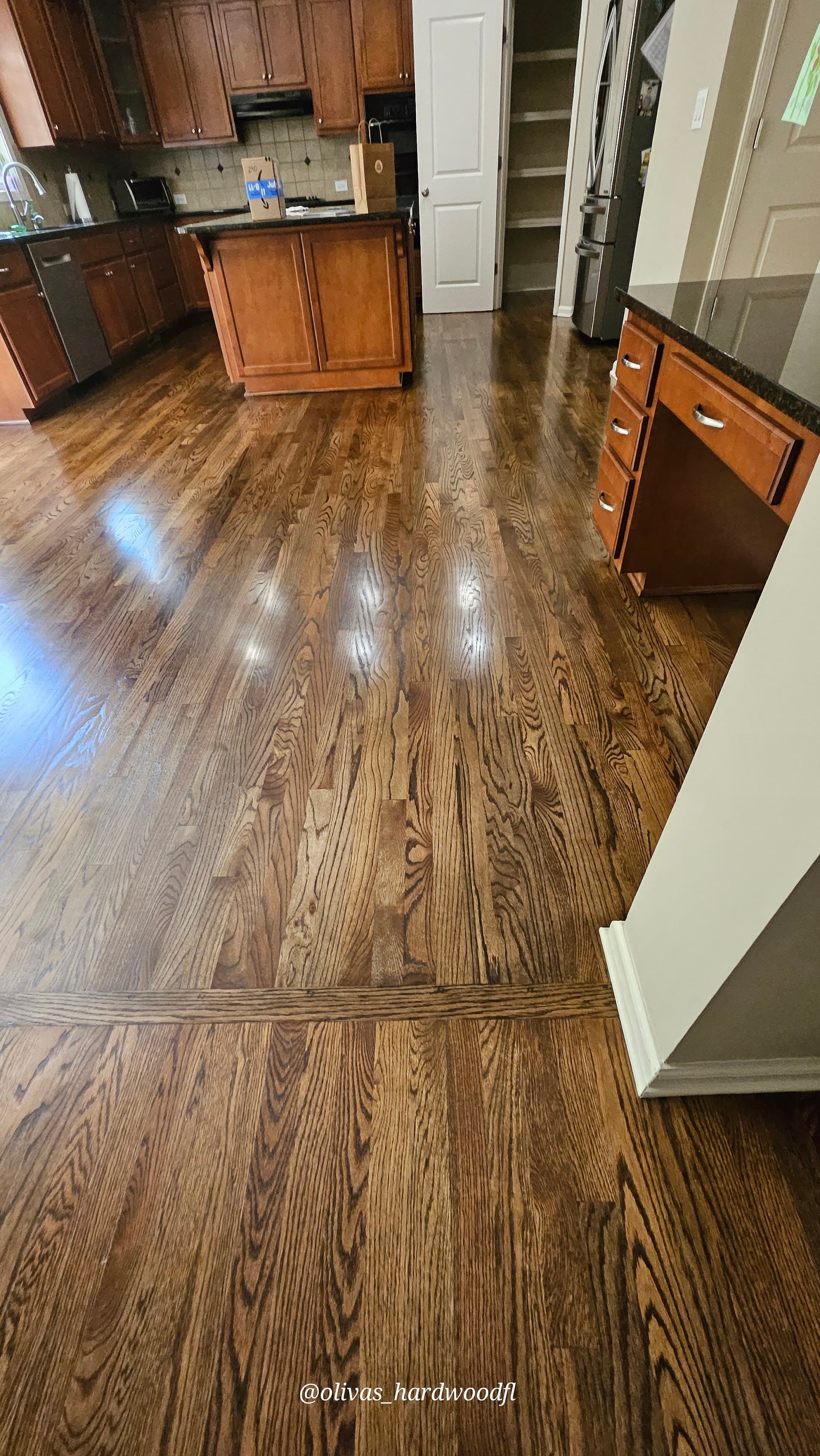 Hardwood floor refinishing in Alpharetta GA — medium brown stain oak open kitchen with island