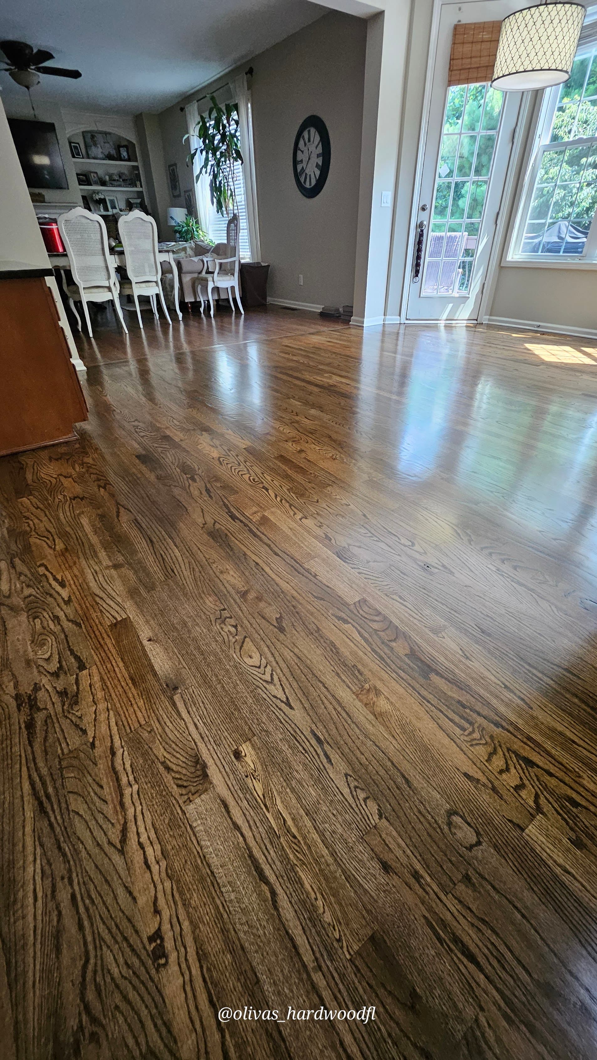 Hardwood floor refinishing in Roswell GA — medium brown stain oak open living and dining room