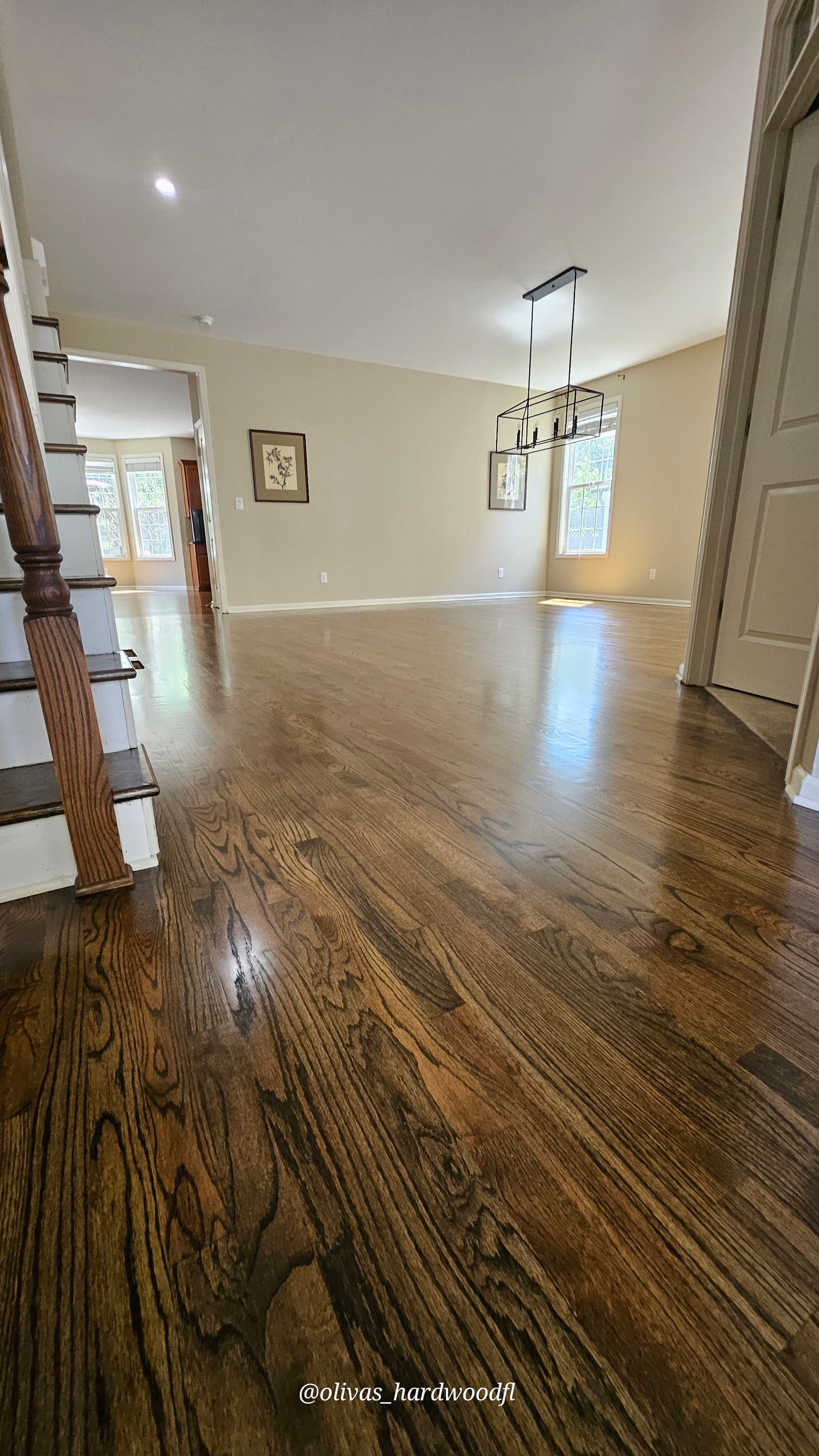 Hardwood floor refinishing in Lawrenceville GA — dark espresso stain on oak open-plan living and dining room