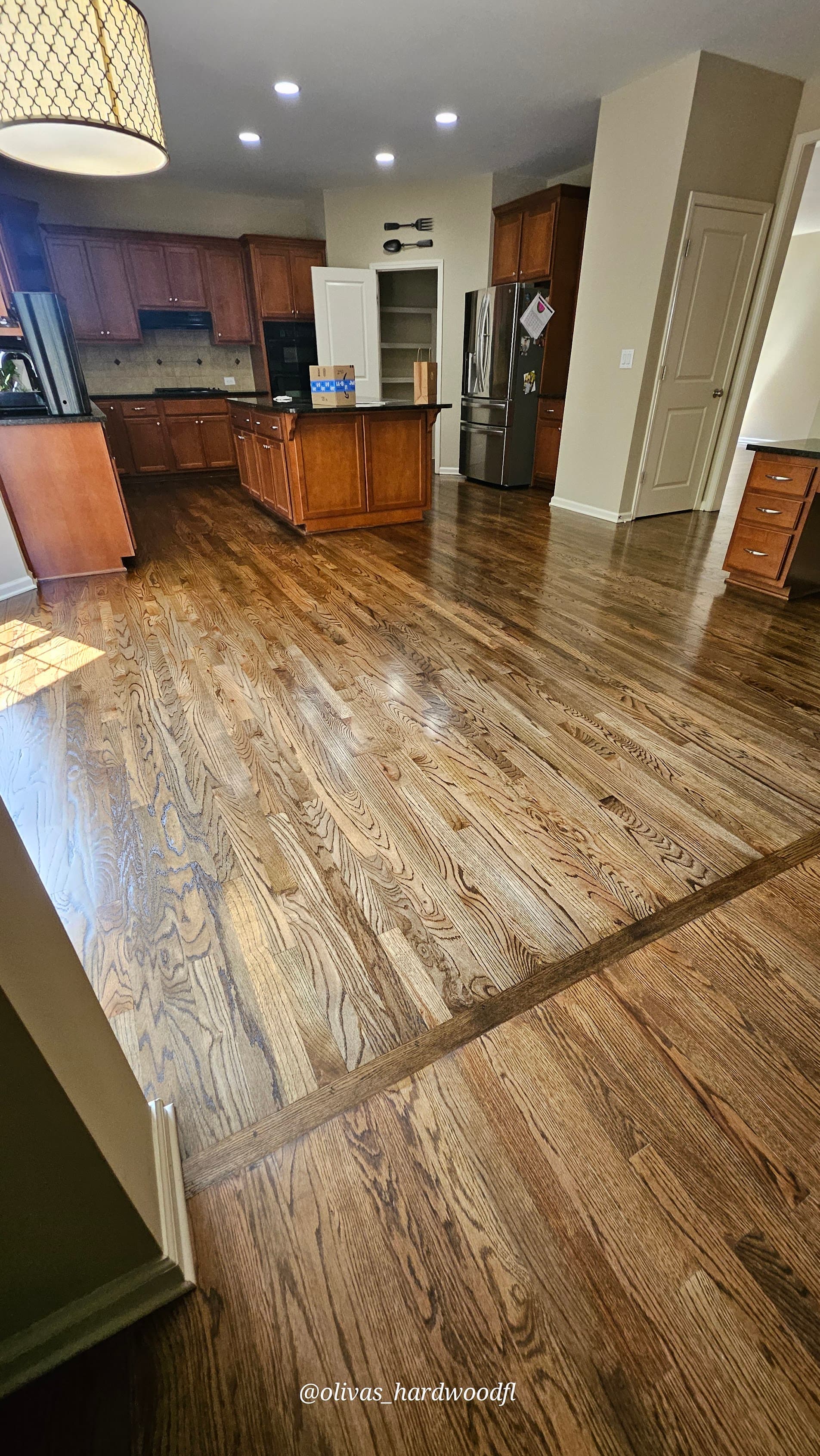 Hardwood floor refinishing in Lawrenceville GA — medium brown stain oak open kitchen with island