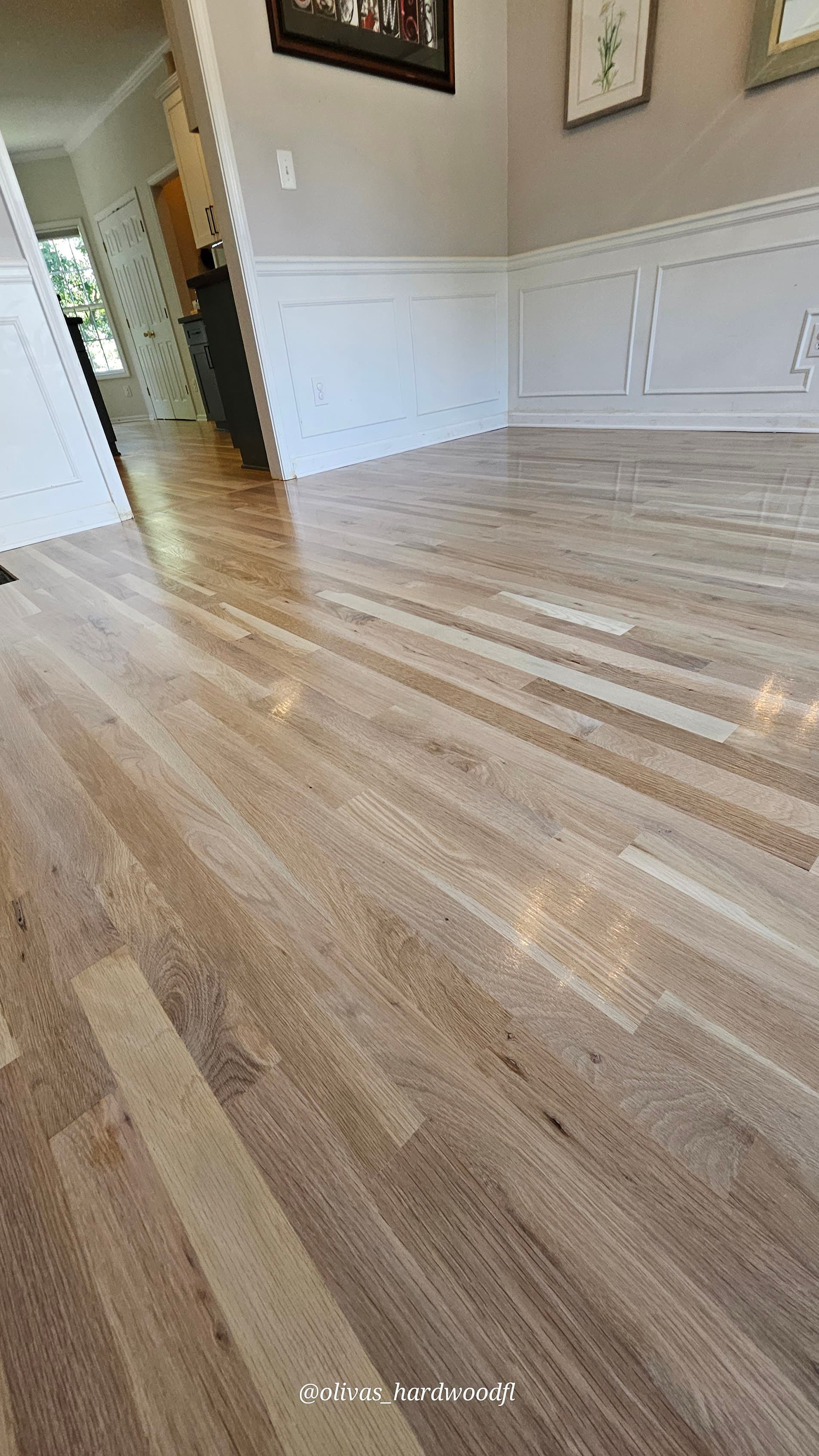 Hardwood floor refinishing in Johns Creek GA — natural white oak satin finish living room with wainscoting trim