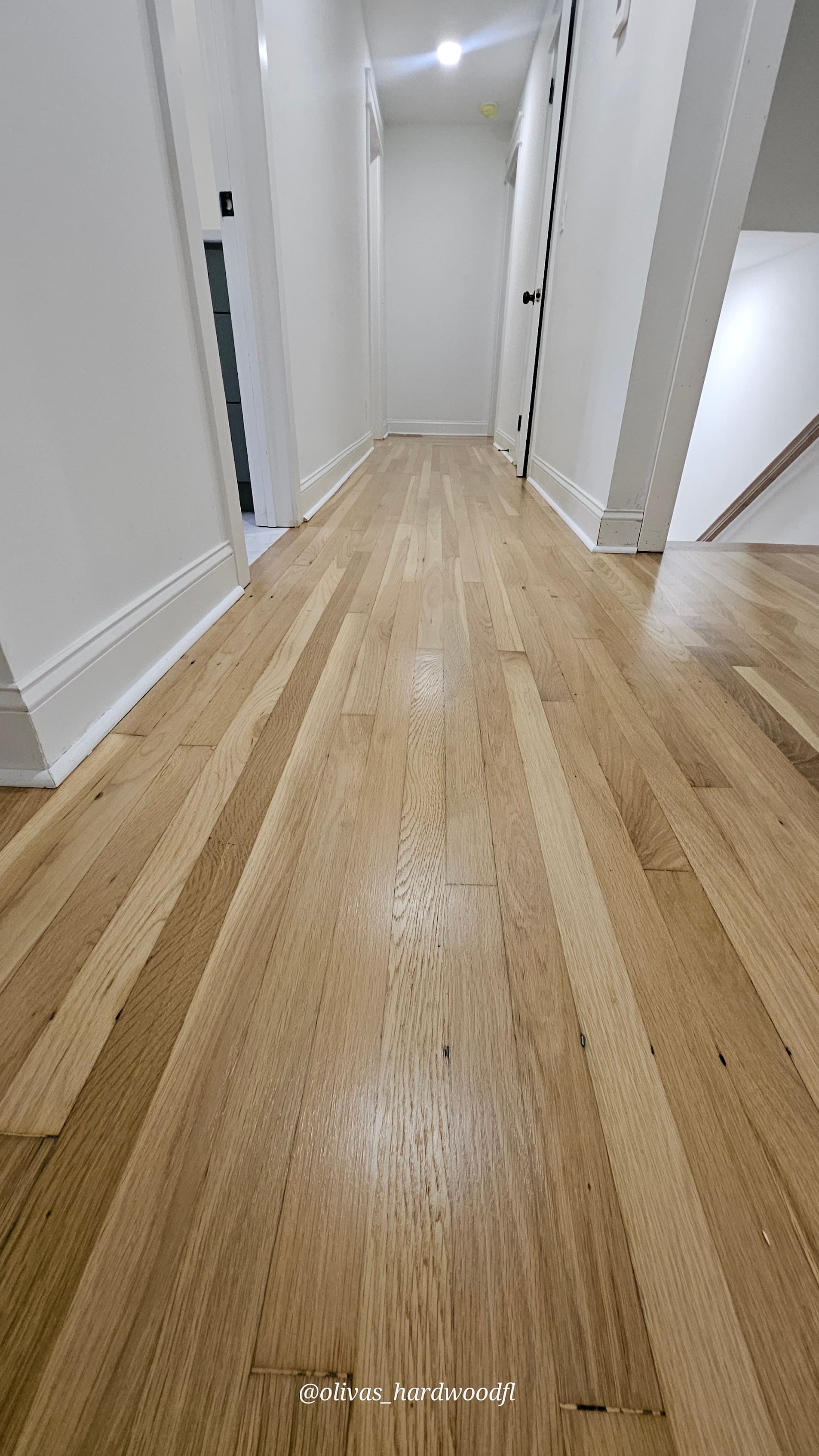 Hardwood floor refinishing in Lawrenceville GA — natural white oak high-gloss hallway