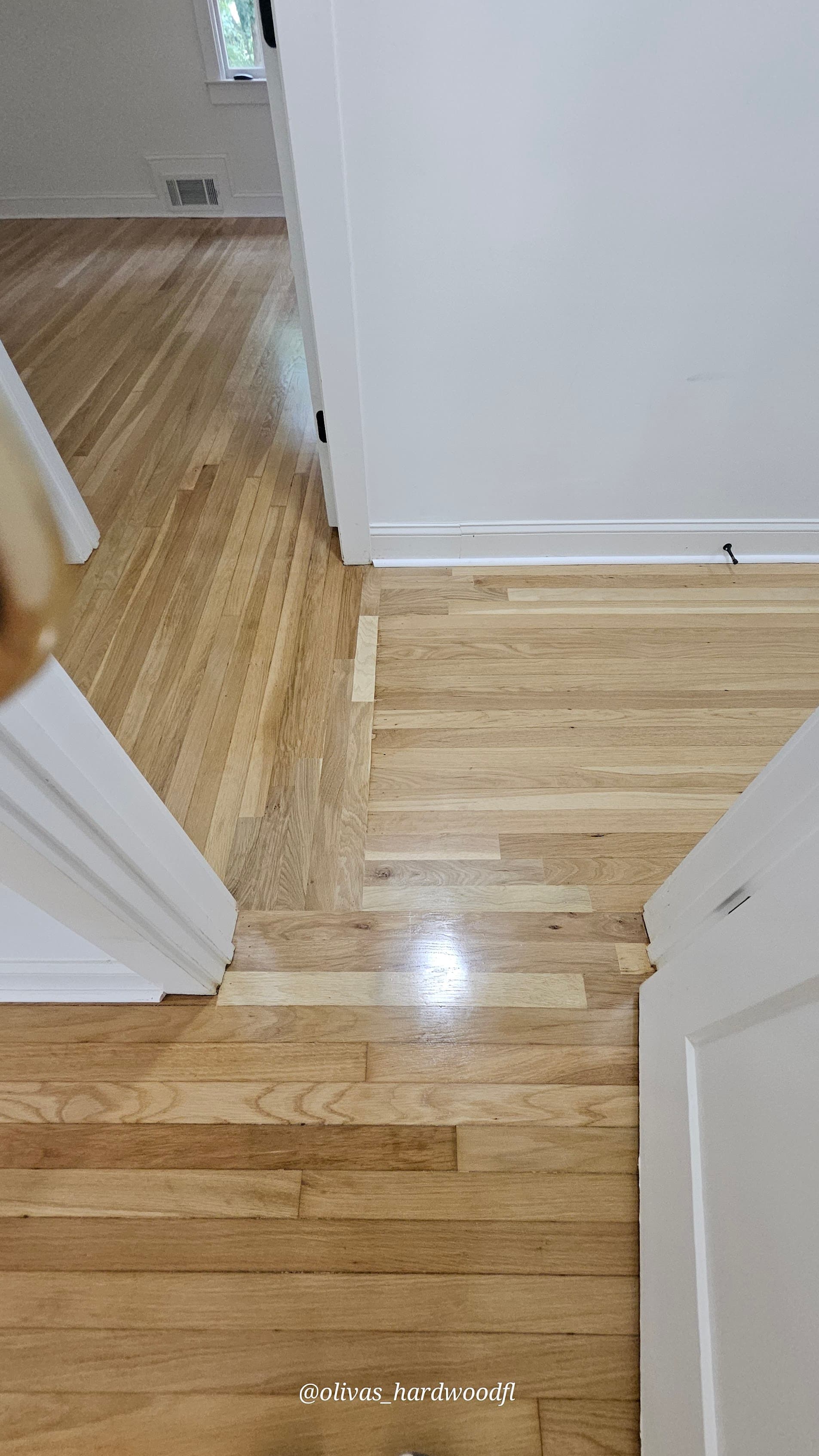 Hardwood floor refinishing in Sandy Springs GA — natural honey oak hallway corner detail