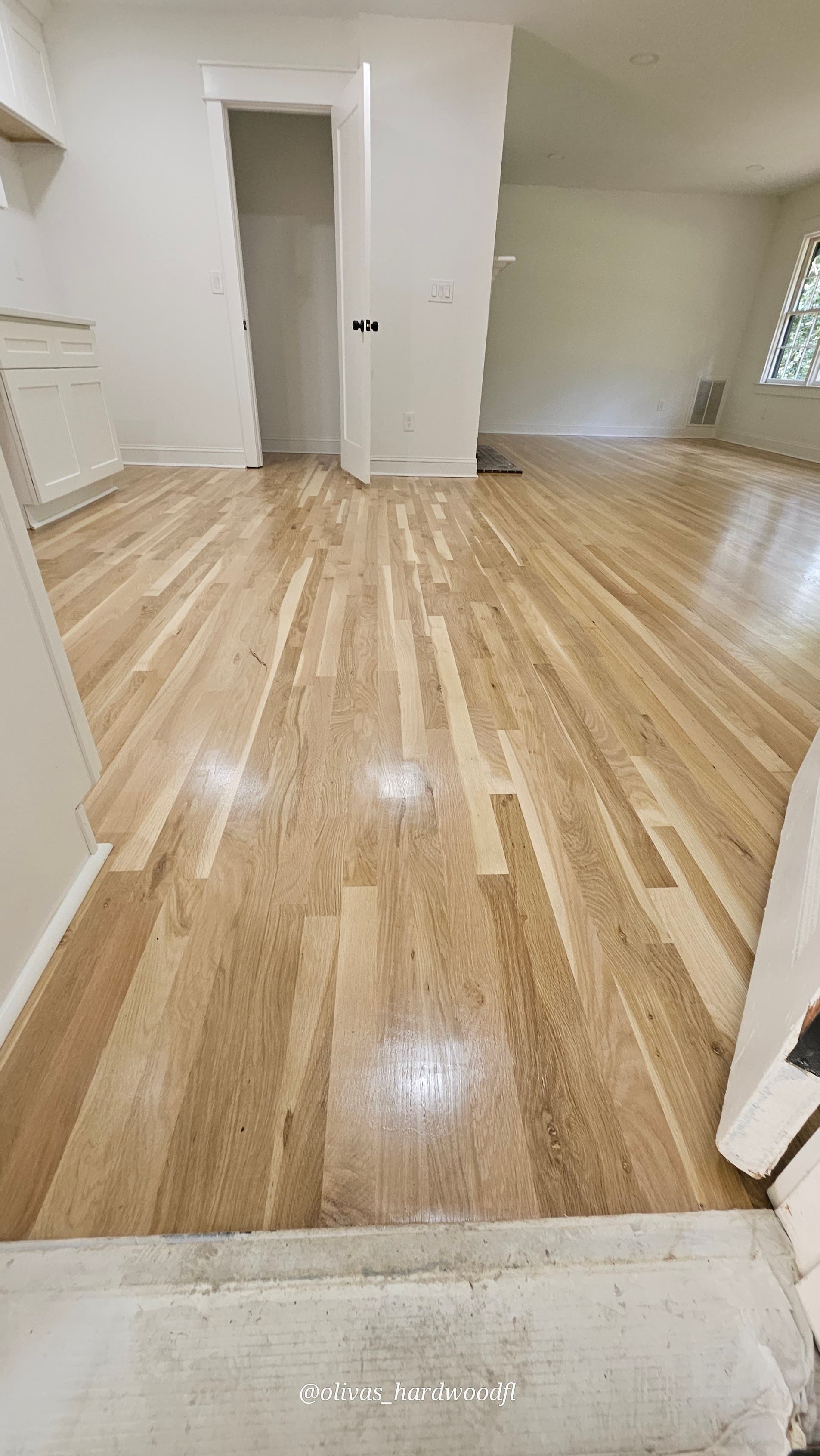 Hardwood floor refinishing in Lawrenceville GA — natural white oak high-gloss open living room