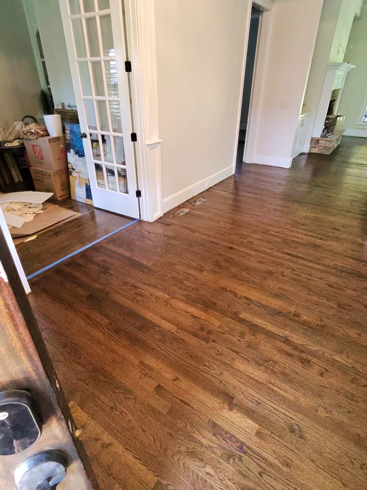 Hardwood floor refinishing in progress in Marietta GA — medium dark brown stain oak living room