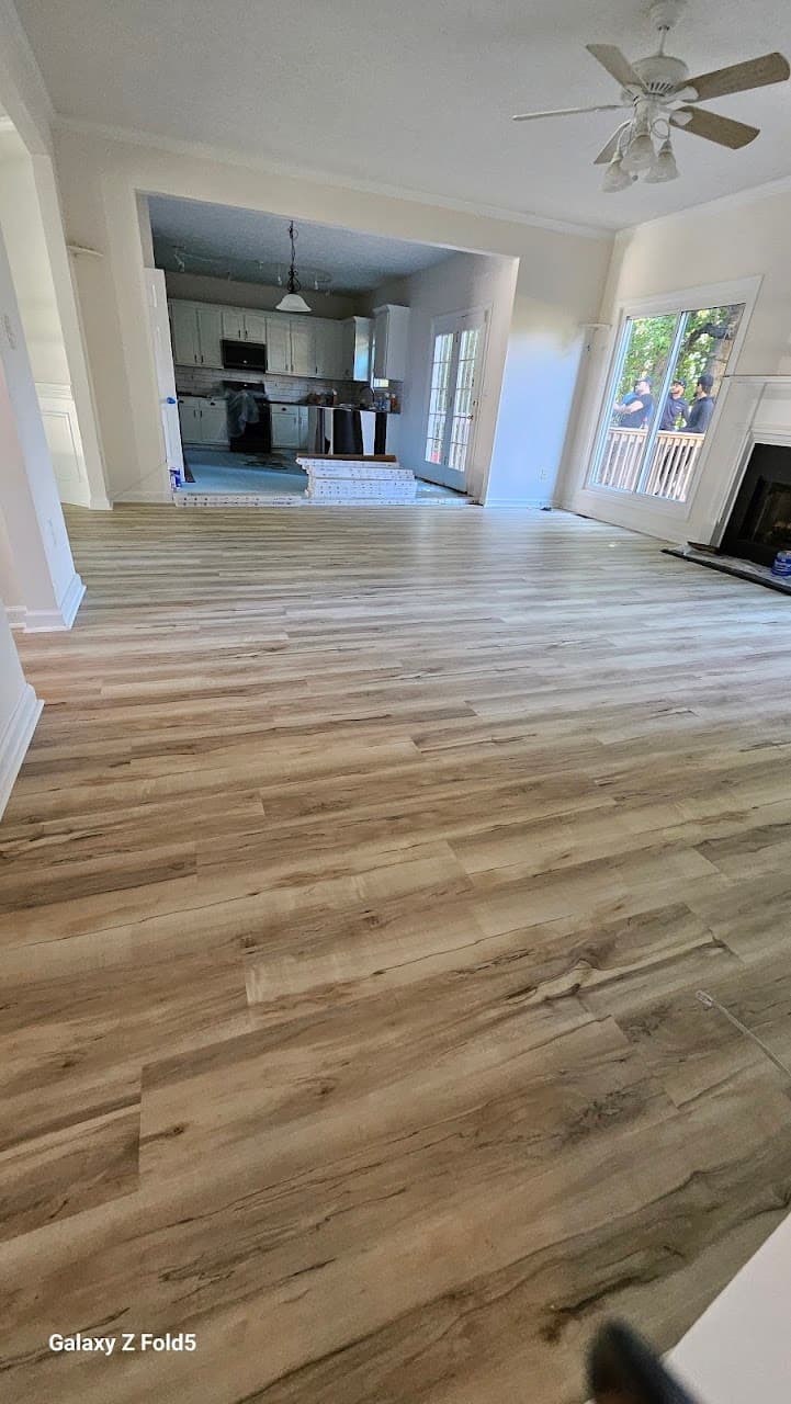 Luxury vinyl plank flooring in Roswell GA — light gray-oak LVP in open living room and kitchen
