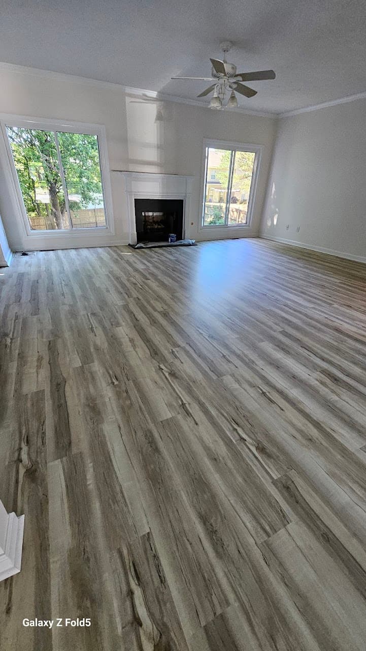 Luxury vinyl plank flooring in Marietta GA — light gray-oak LVP in living room with fireplace