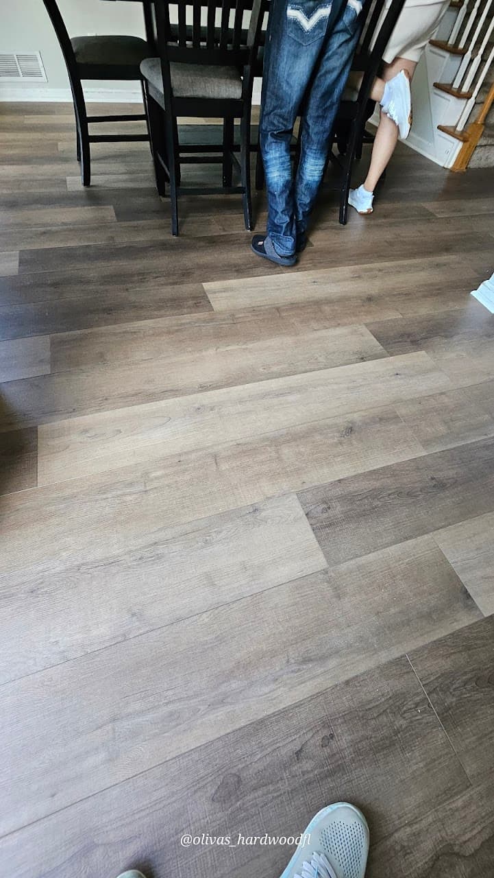 Luxury vinyl plank flooring in Marietta GA — gray-brown LVP in dining room with dark furniture