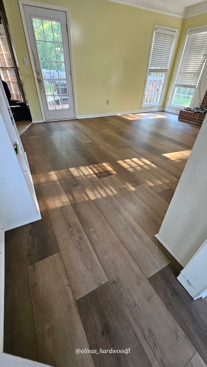 Luxury vinyl plank flooring in Duluth GA — gray-brown LVP in living room with yellow walls