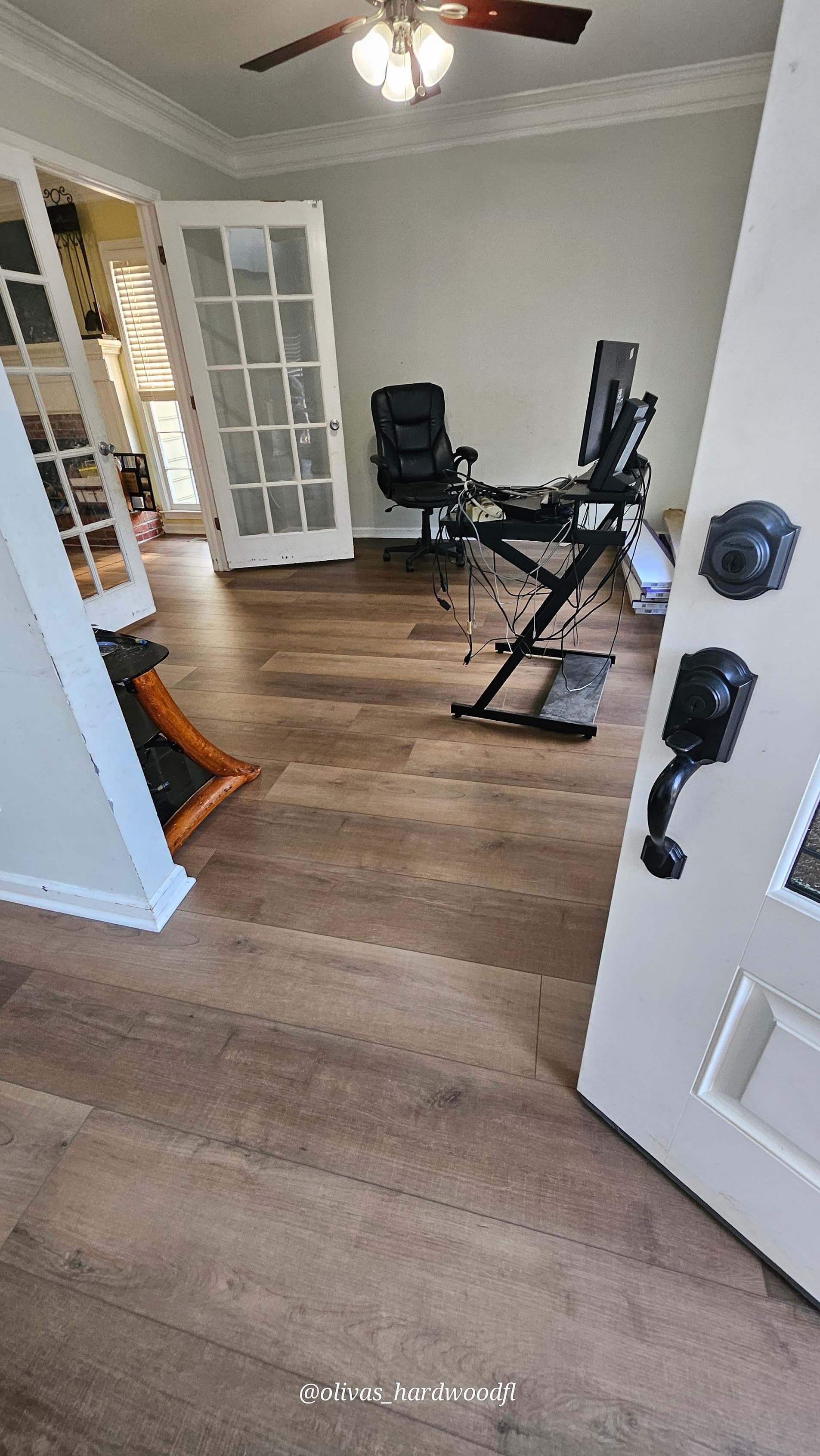 Luxury vinyl plank flooring in Gwinnett County GA — gray-brown LVP in home office with French doors