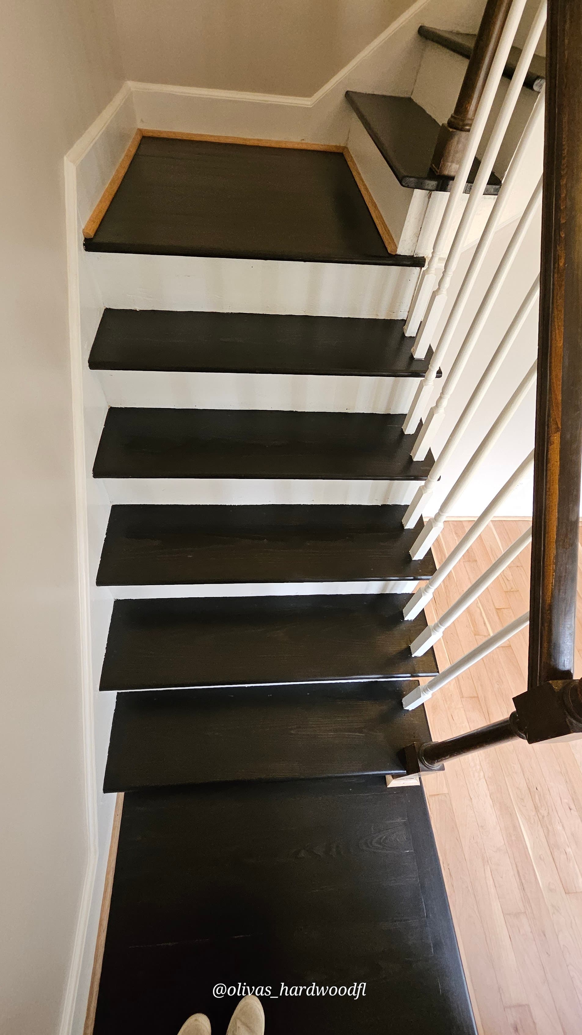 Staircase renovation in Duluth GA — dark ebony oak treads and white risers after professional refinishing