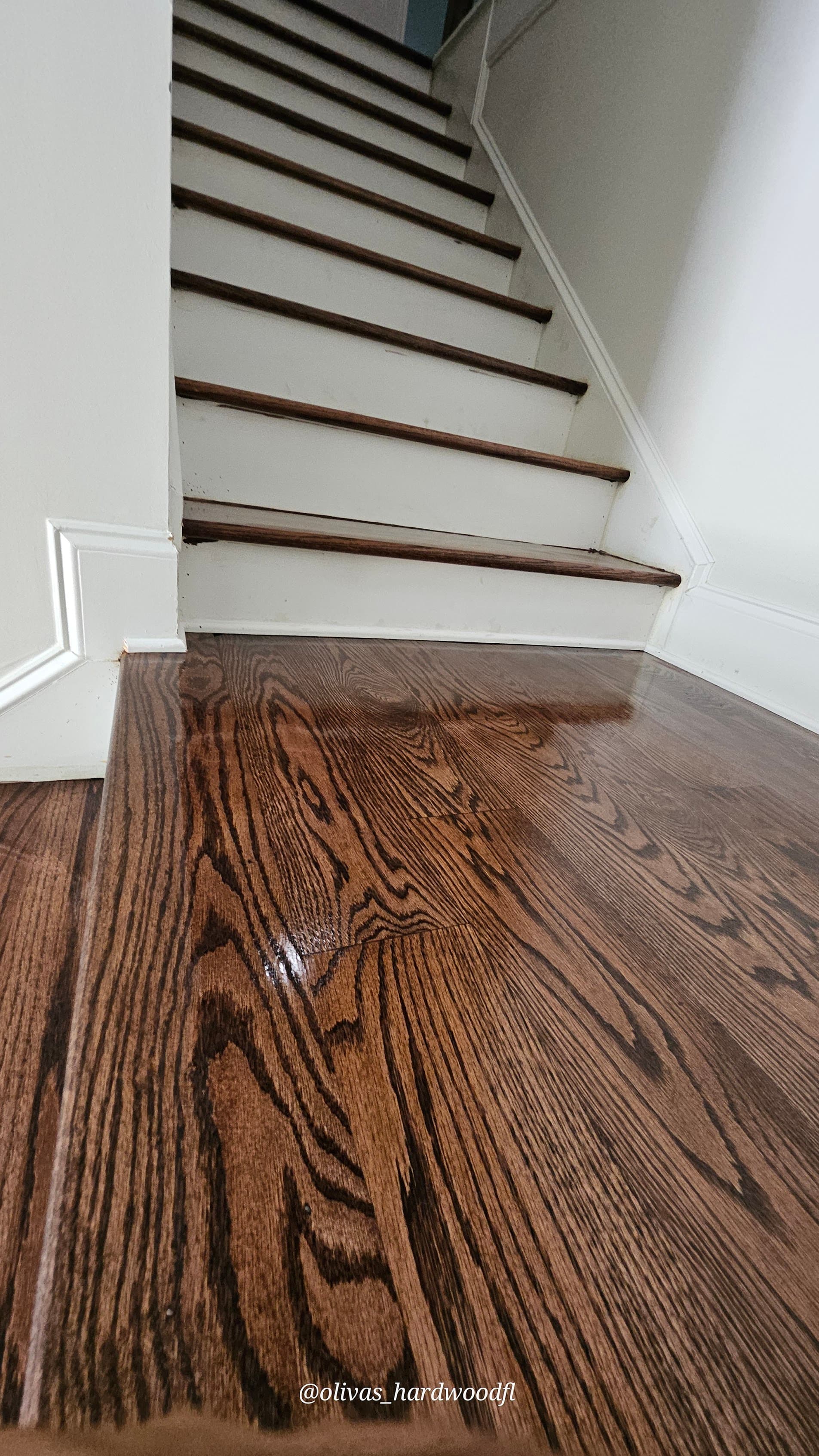 Staircase renovation in Atlanta GA — dark espresso oak treads with white risers matching hardwood floors