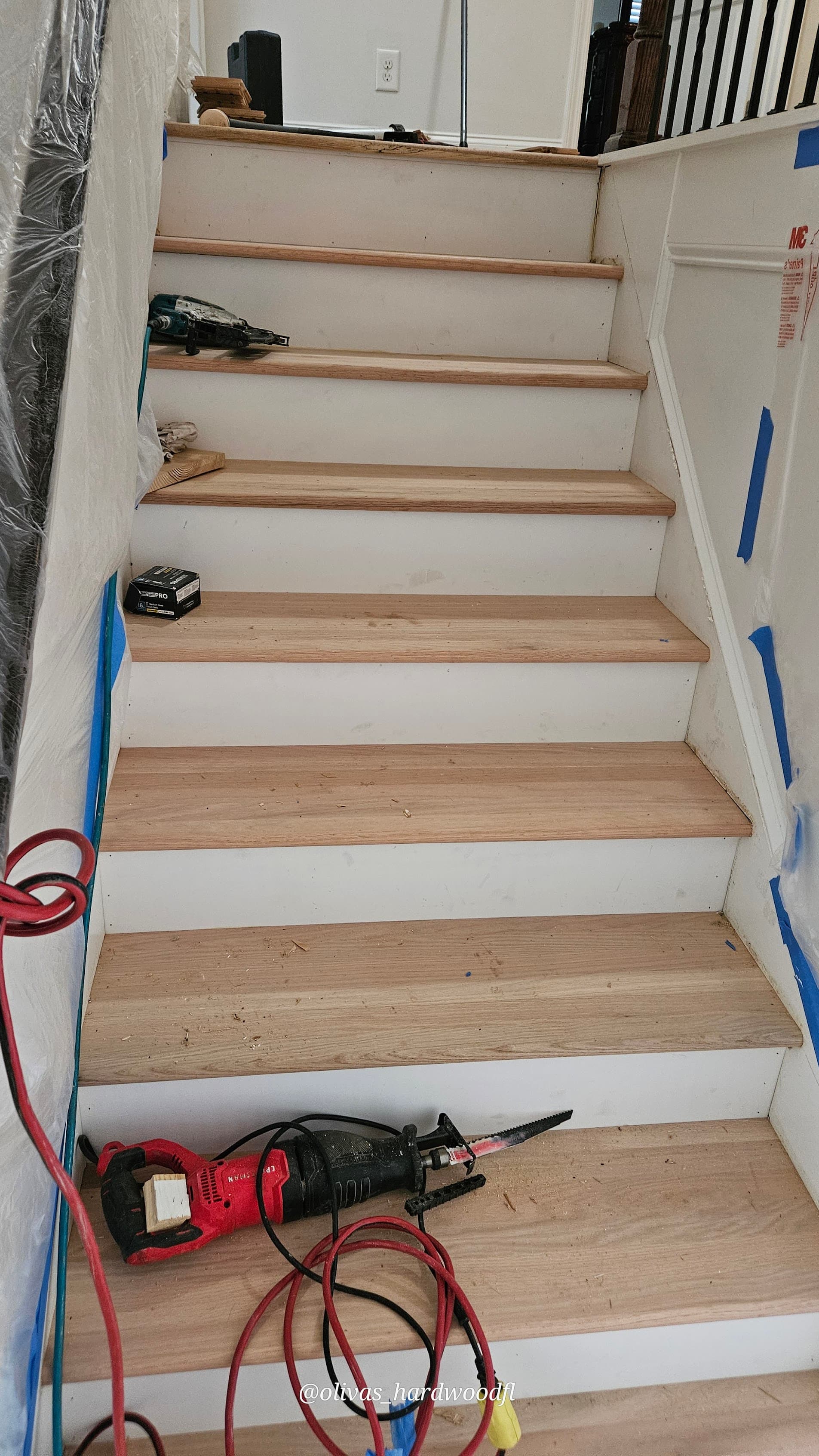 Staircase renovation in progress in Lawrenceville GA — natural oak treads being installed