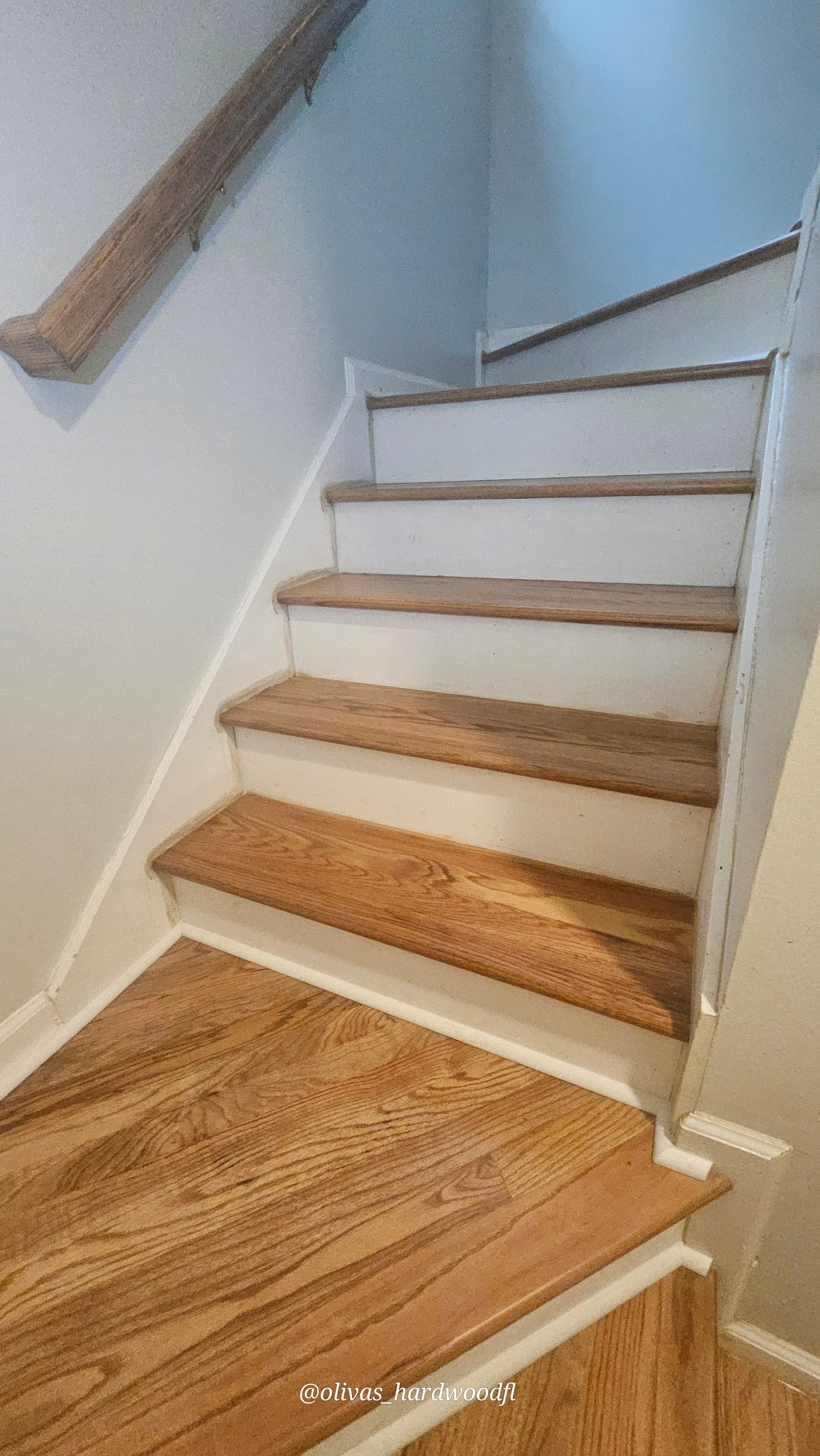 Staircase renovation in Marietta GA — natural oak treads with white risers and simple wood handrail