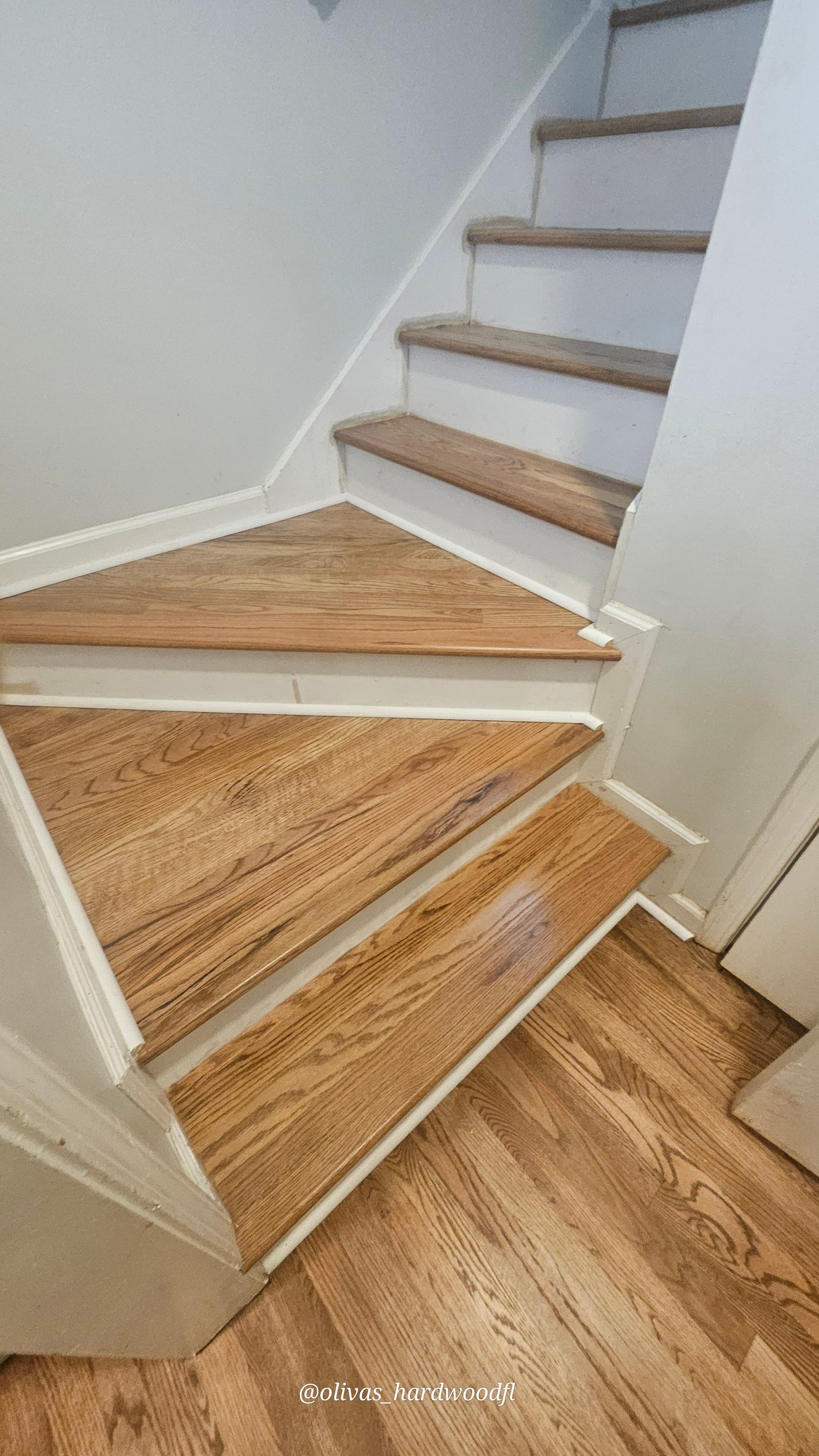 Staircase renovation in Atlanta GA — natural oak winder treads with white painted risers