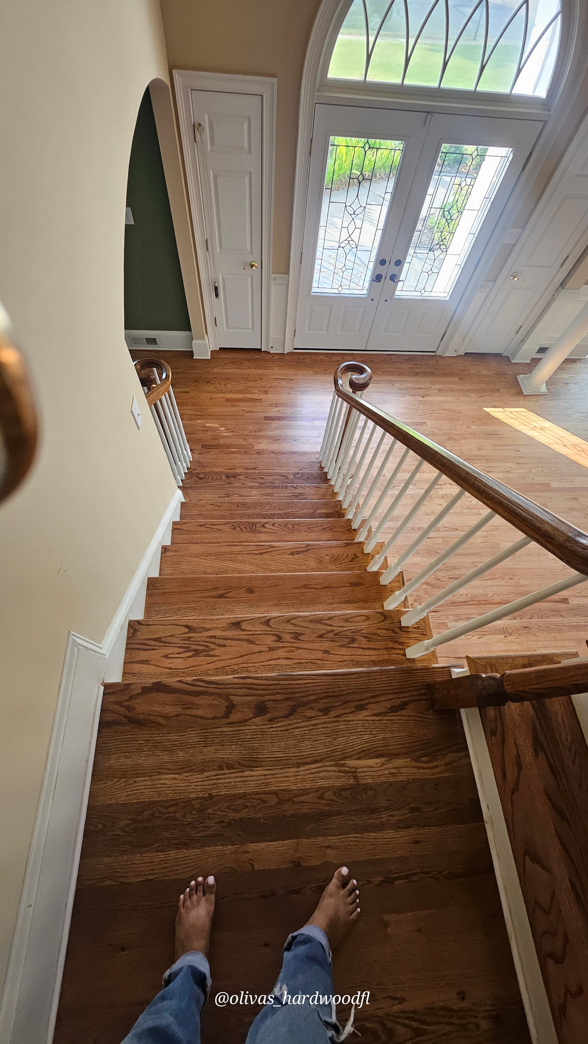 Staircase renovation in Alpharetta GA — top view of oak treads looking down at hardwood foyer