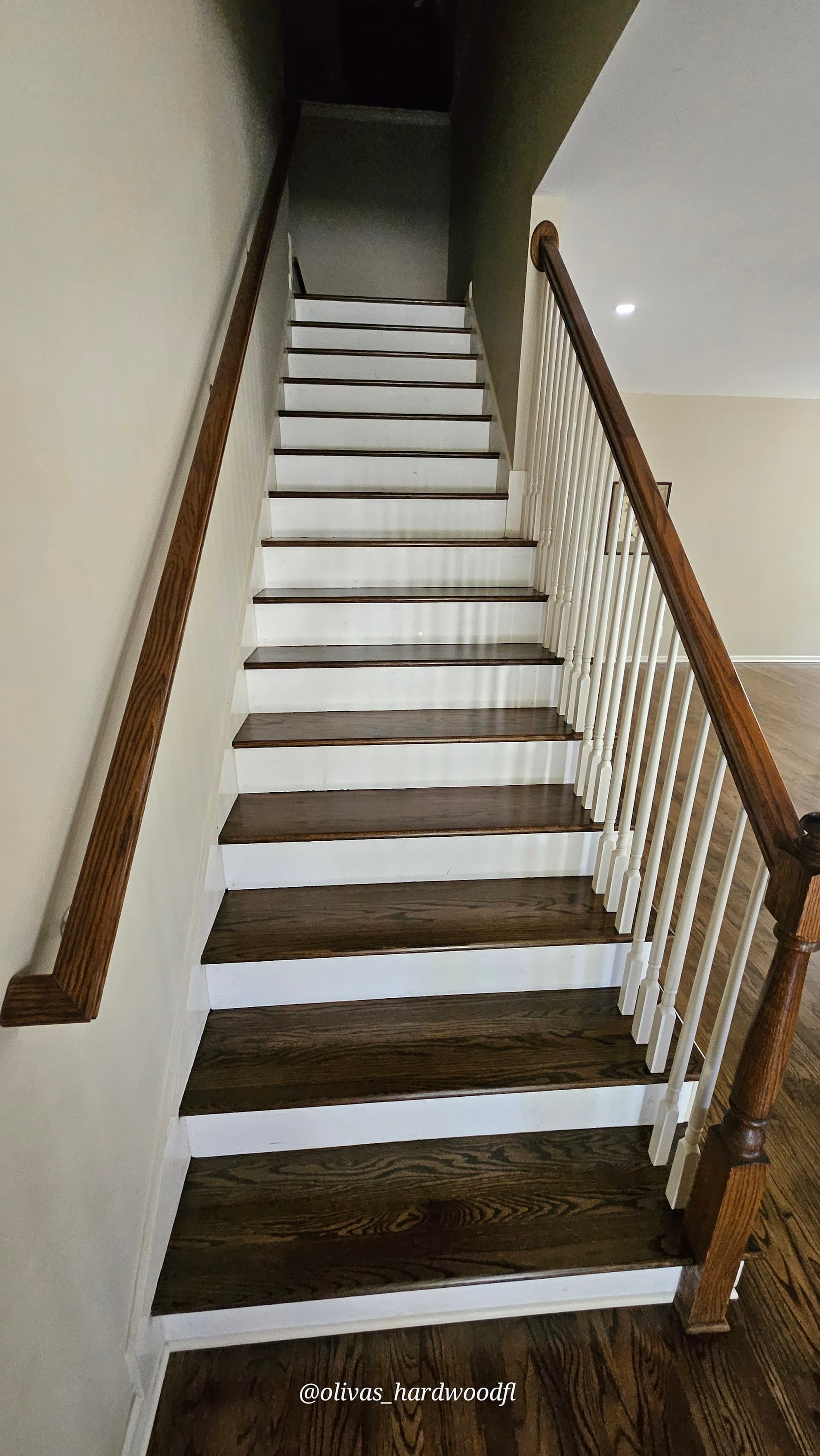 Staircase renovation in Lawrenceville GA — dark stain oak treads with white painted risers and wood balusters