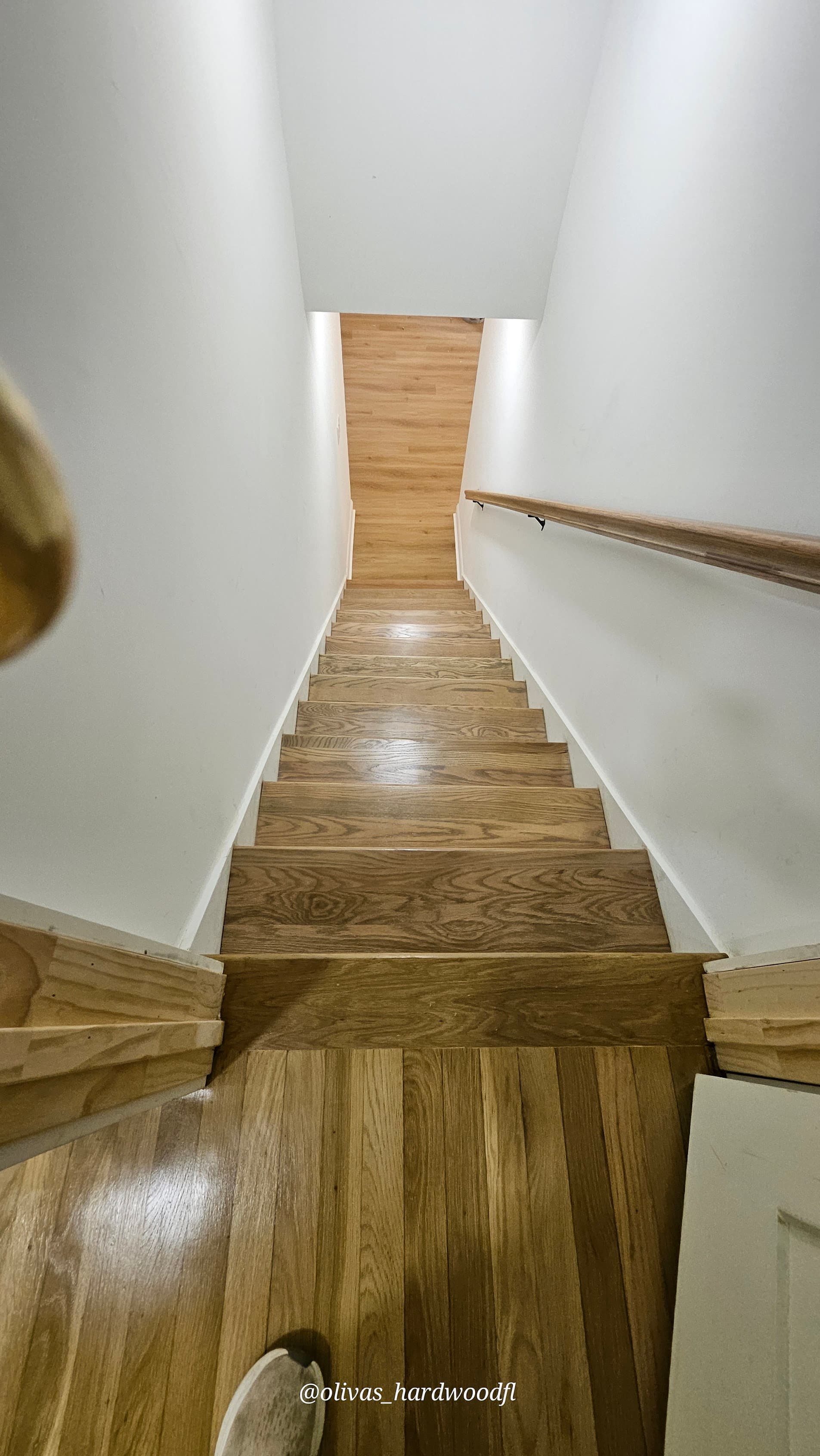 Staircase renovation in Atlanta GA — top-down view of natural oak medium stain treads