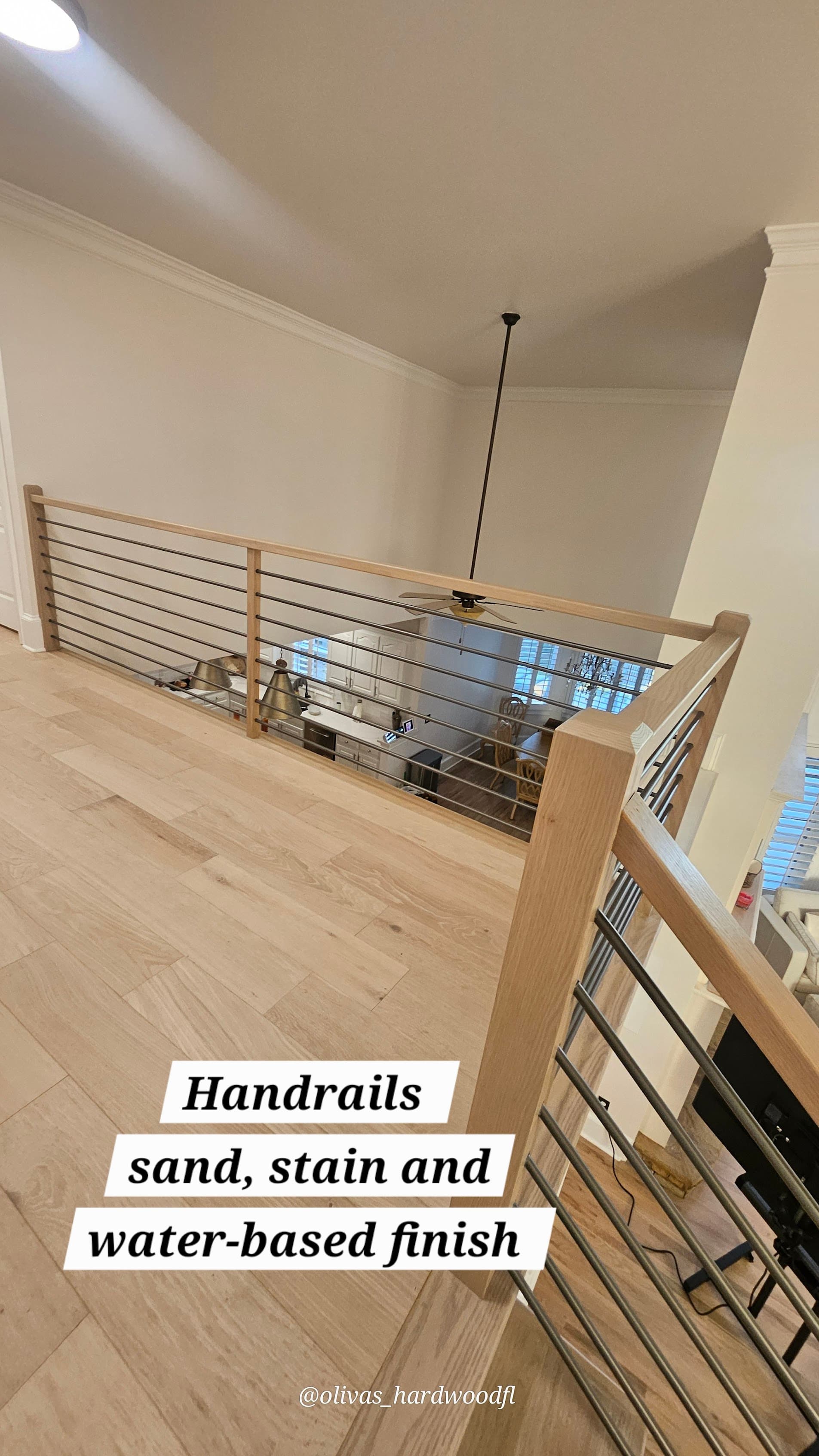 Staircase renovation in Marietta GA — natural oak handrail and landing with modern horizontal rod balusters