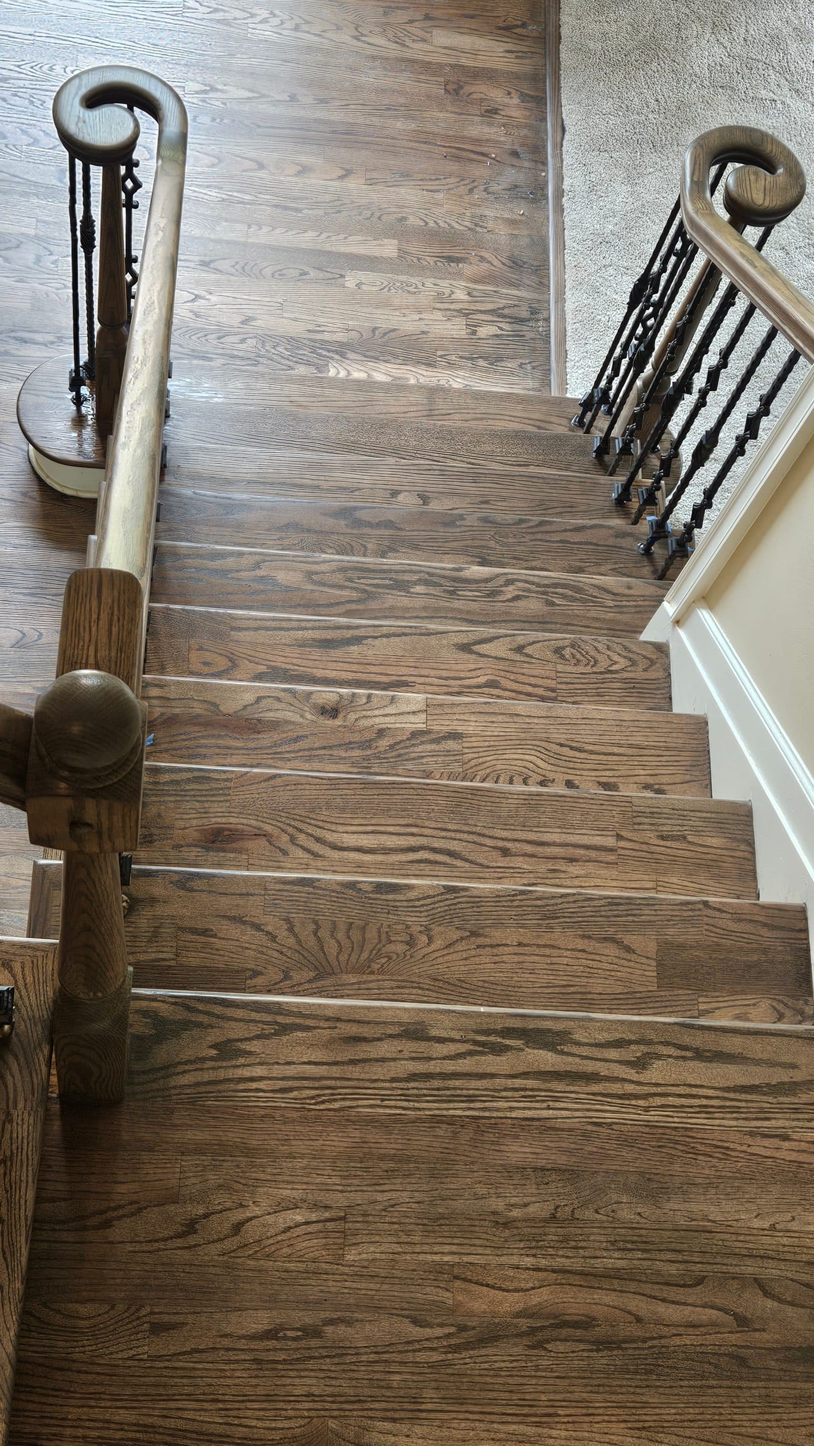 Staircase renovation in Atlanta GA — medium brown stain oak treads on the upper flight of stairs